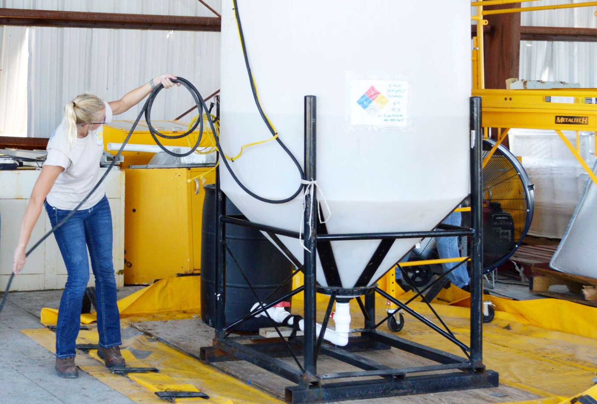 Research scientist Kara Griffith gathers the electrical cable mounted to the in-house mixing apparatus before the start of a backfill test July 16, 2019 at the 9700 Area at Tyndall Air Force Base, Florida. (U.S. Air Force photo by David Ford)