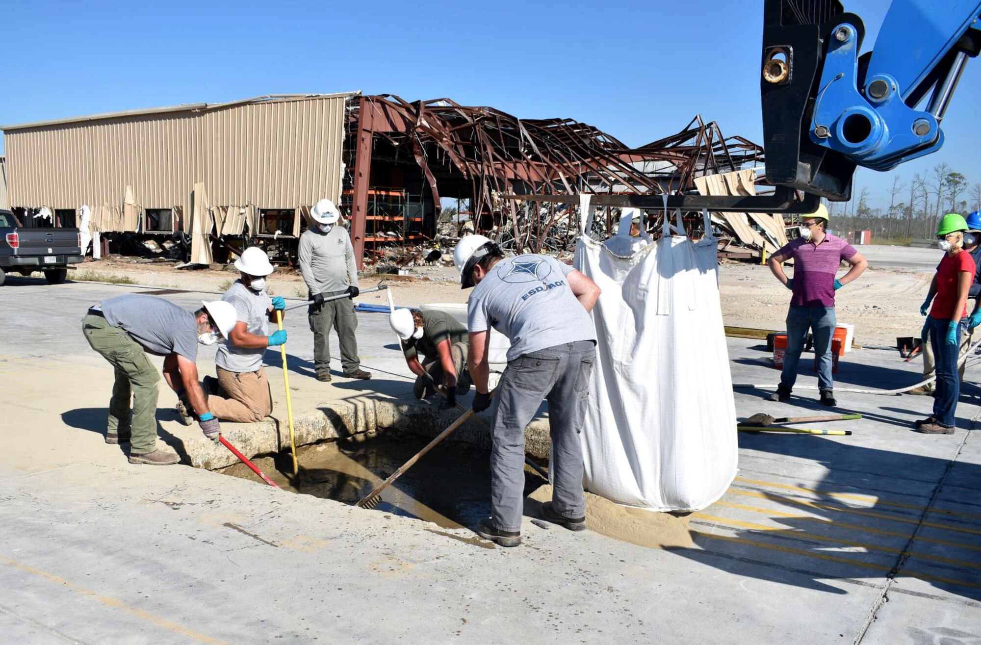 The pavements team with the Air Force Civil Engineer Center prepares and ensures the materiel mix is correct during the backfill event on July 16, 2019 at the 9700 Area at Tyndall Air Force Base, Florida. (U.S. Air Force photo by Grace Bland)