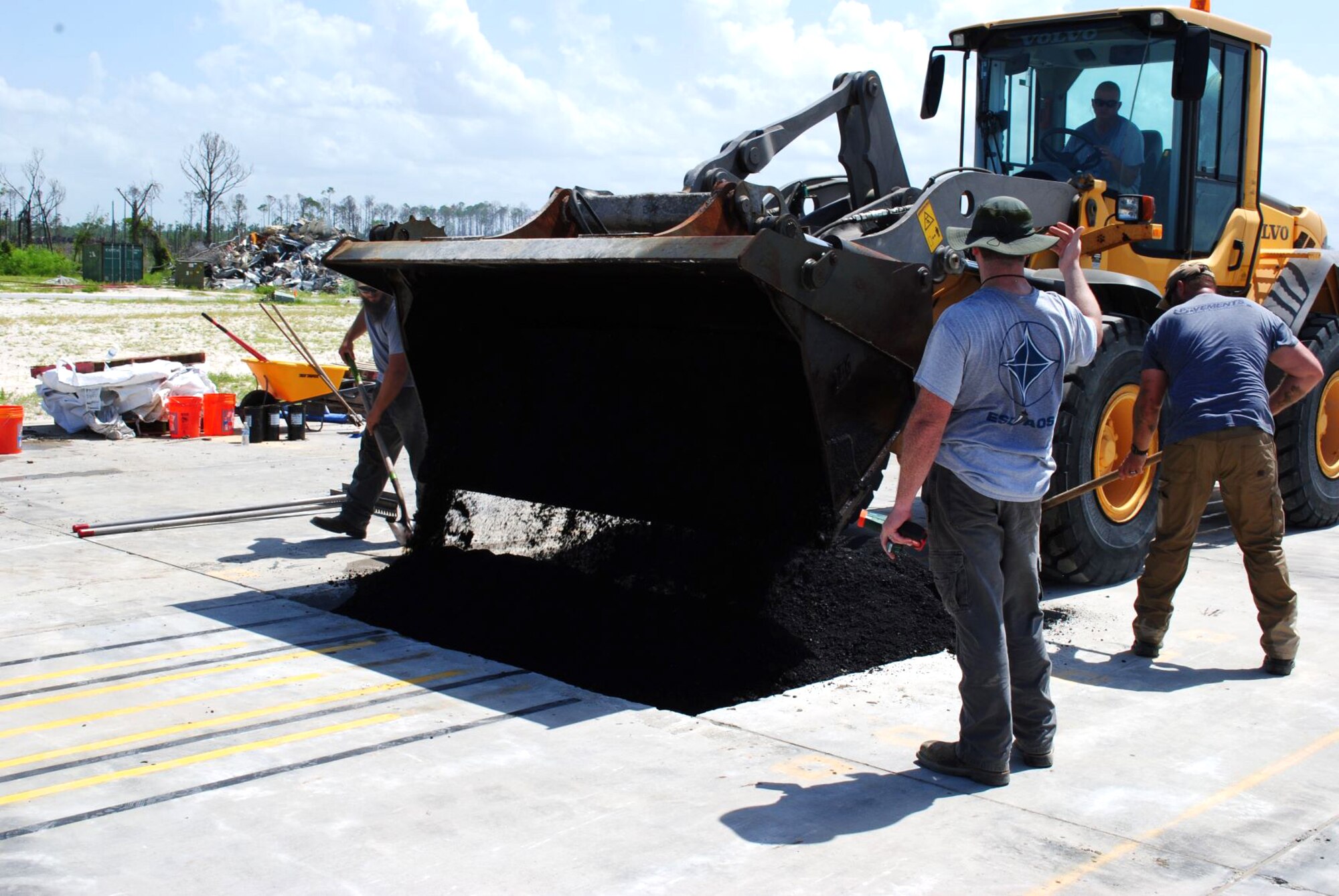The pavements team with the Air Force Civil Engineer Center drops and evens out asphalt on top of the backfill material on July 16, 2019 at the 9700 Area at Tyndall Air Force Base, Florida. (U.S. Air Force photo by Grace Bland)