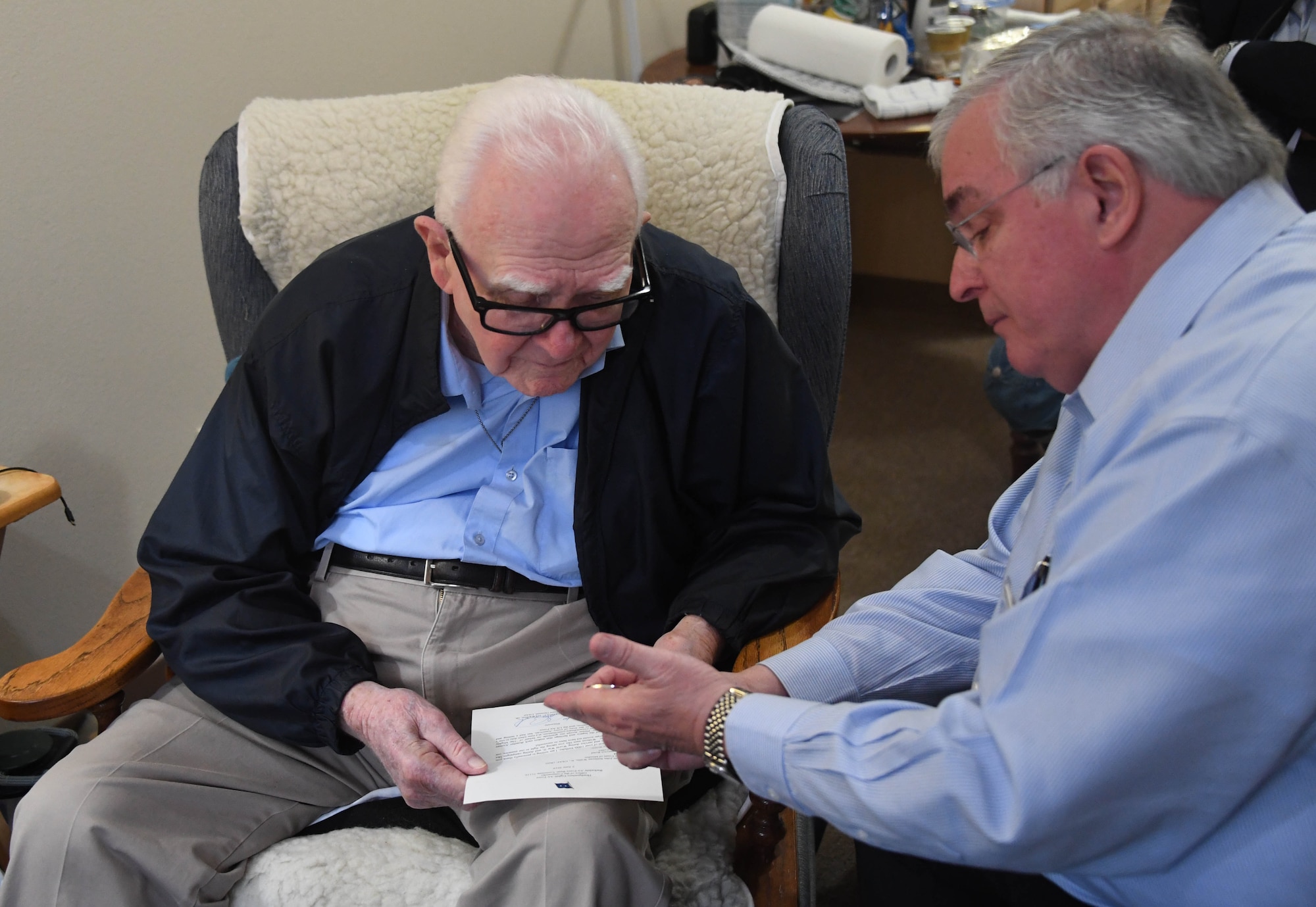 Eighth Air Force historian, Lane Callaway, right, presents a letter of appreciation and commemorative coin on behalf of Maj. Gen. James Dawkins, Jr., 8th Air Force commander, to Army Air Corps First Lt. John Willis, Jr., at his home in Minden, La., Dec. 10. Willis is a World War II vet who was assigned to the 728th Bomb Squadron and is a Distinguished Flying Cross recipient. Willis recently celebrated his 100th birthday and participated in the Barksdale Field dedication ceremony back in February 1933. (U.S. Air Force photo by Justin Oakes)