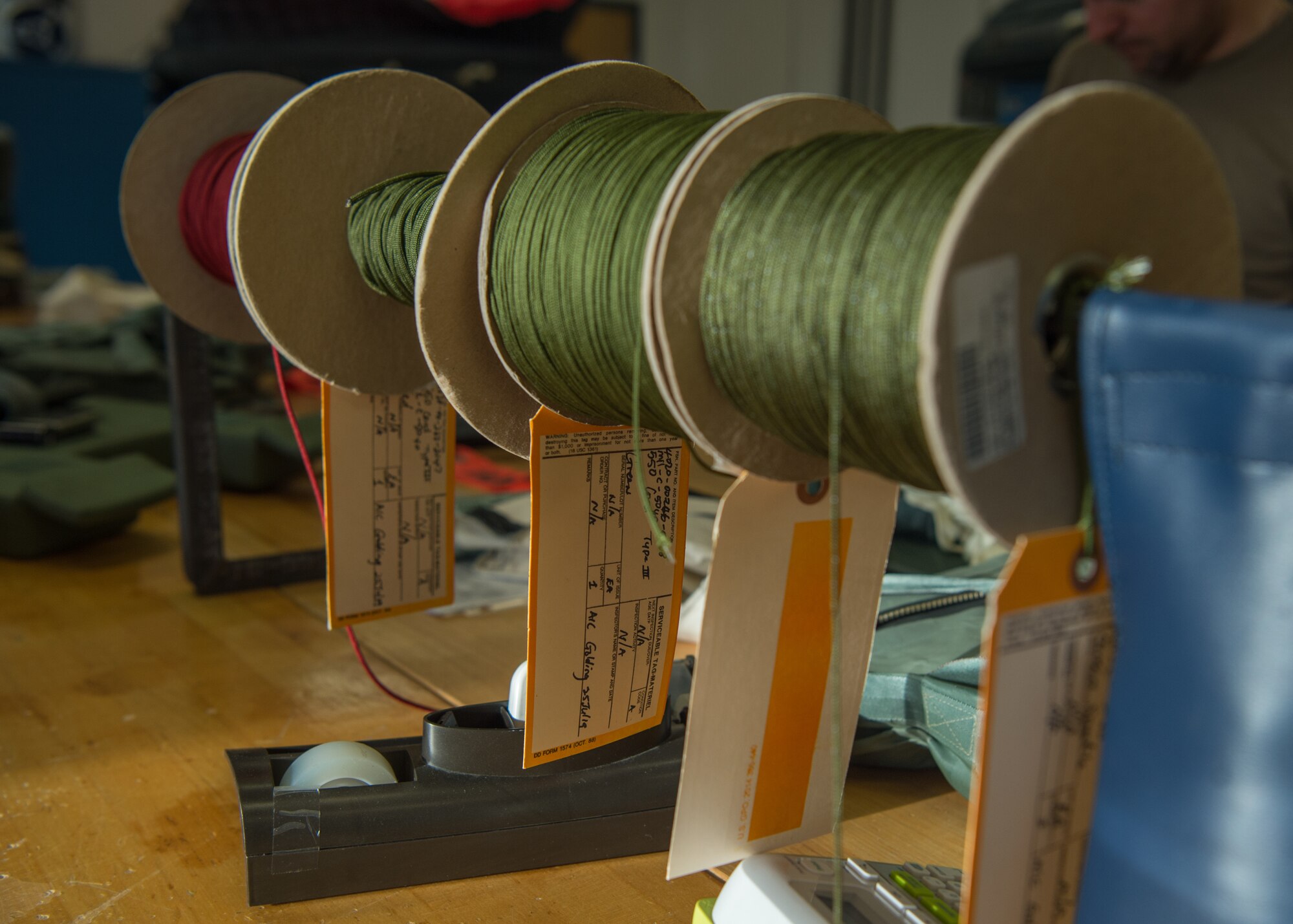 Different sizes of cord sit on spools at the 1st Operations Support Squadron aircrew flight equipment shop at Joint Base Langley-Eustis, Virginia, Dec. 10, 2019.