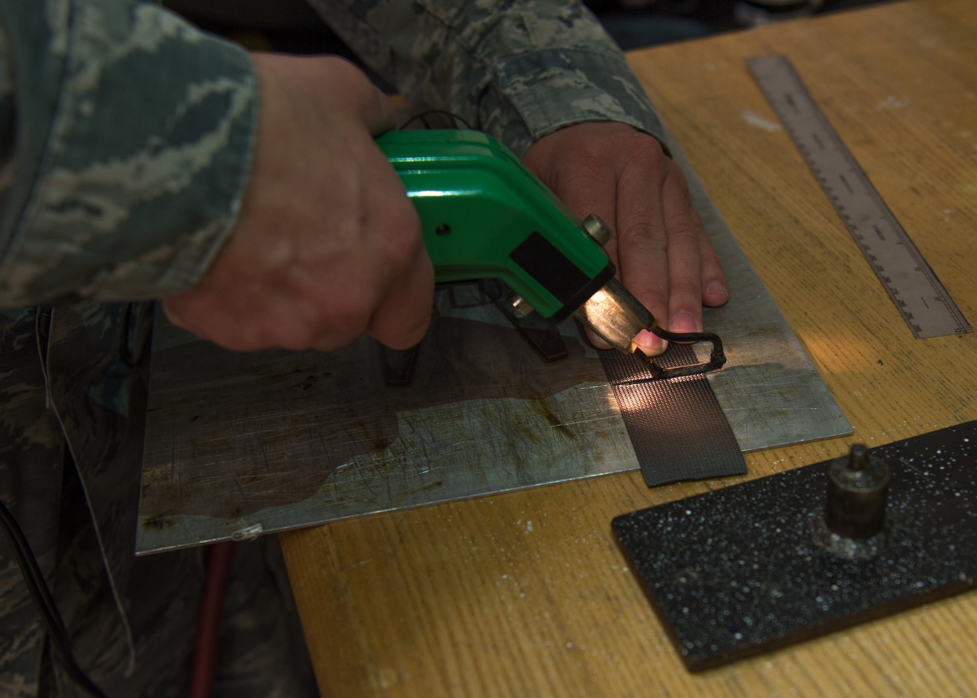 U.S. Air Force Staff Sgt. Blake Hendricks, 1st Operations Support Squadron aircrew flight equipment technician, conducts a metal stiffener reinforcement repair at Joint Base Langley-Eustis, Virginia, Dec. 10, 2019.