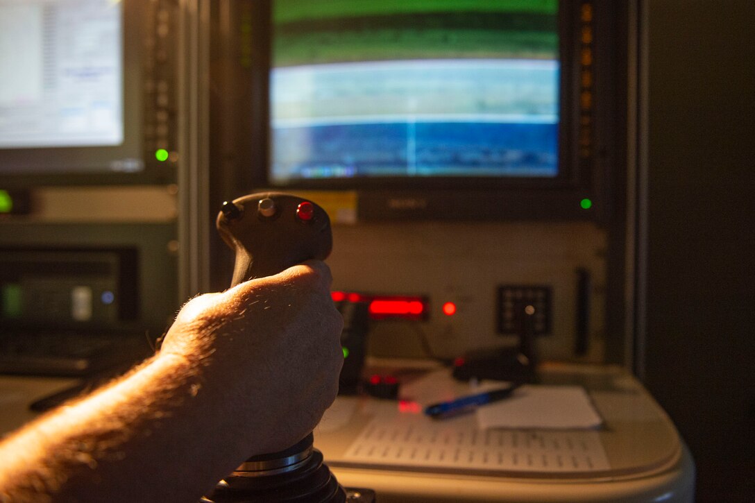 Photo of Airmen pinpointing the location of a bomb using the Weapons Impact Scoring System.