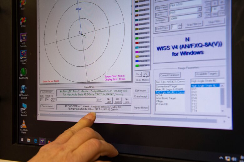 Photo of an Airman reviewing scores on the Weapons Impact Scoring System.