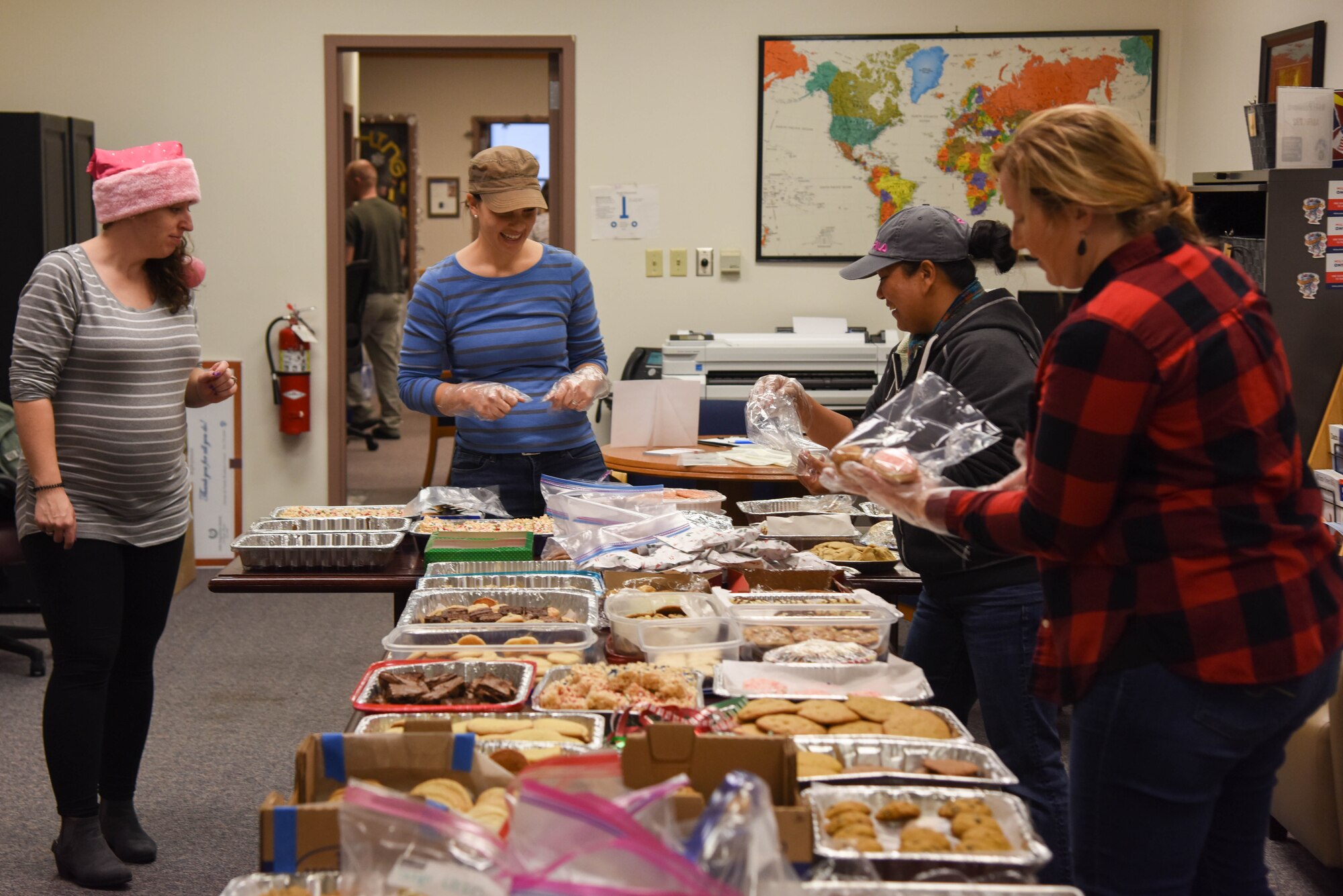 Volunteers from around the 22nd Air Refueling Wing package cookies at the Airmen and Family Readiness Center Dec. 12, 2019, at McConnell Air Force Base, Kan. The event was aimed toward raising morale for Airmen living on base. (U.S. Air Force photo by Airman 1st Class Marc A. Garcia)