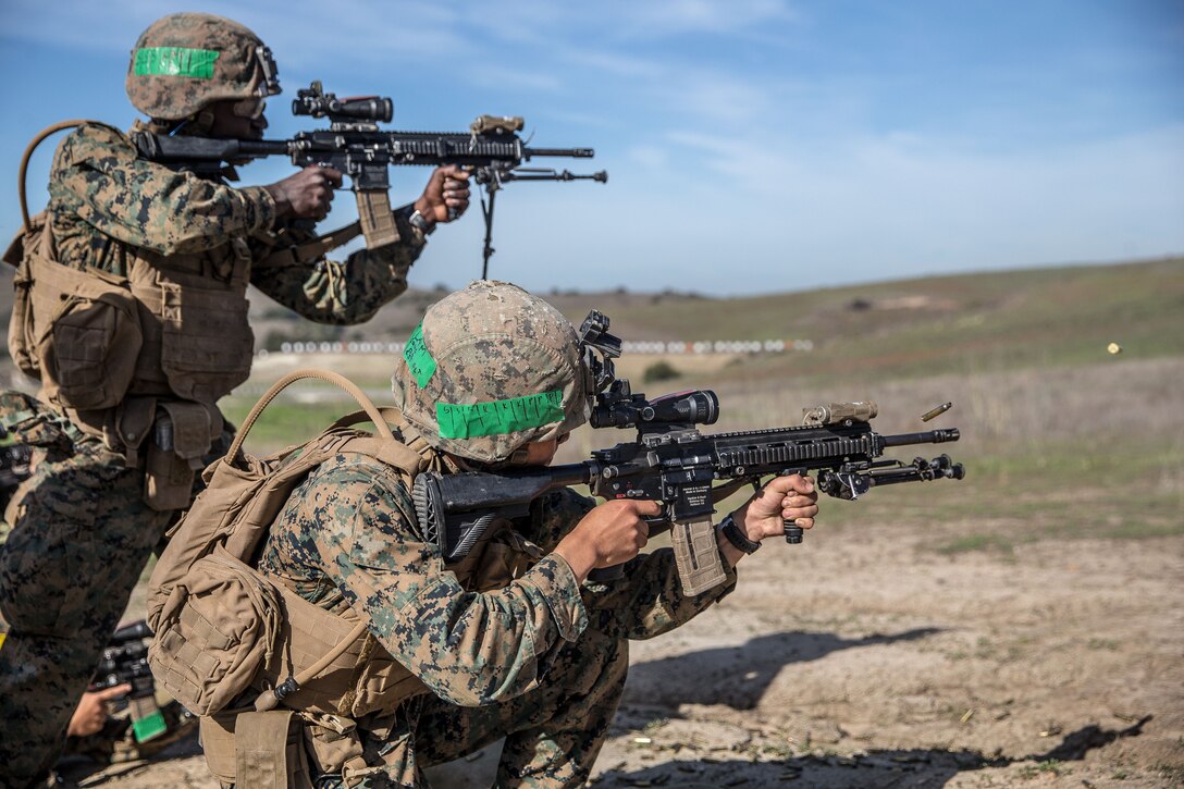 Marines fire weapons on range.
