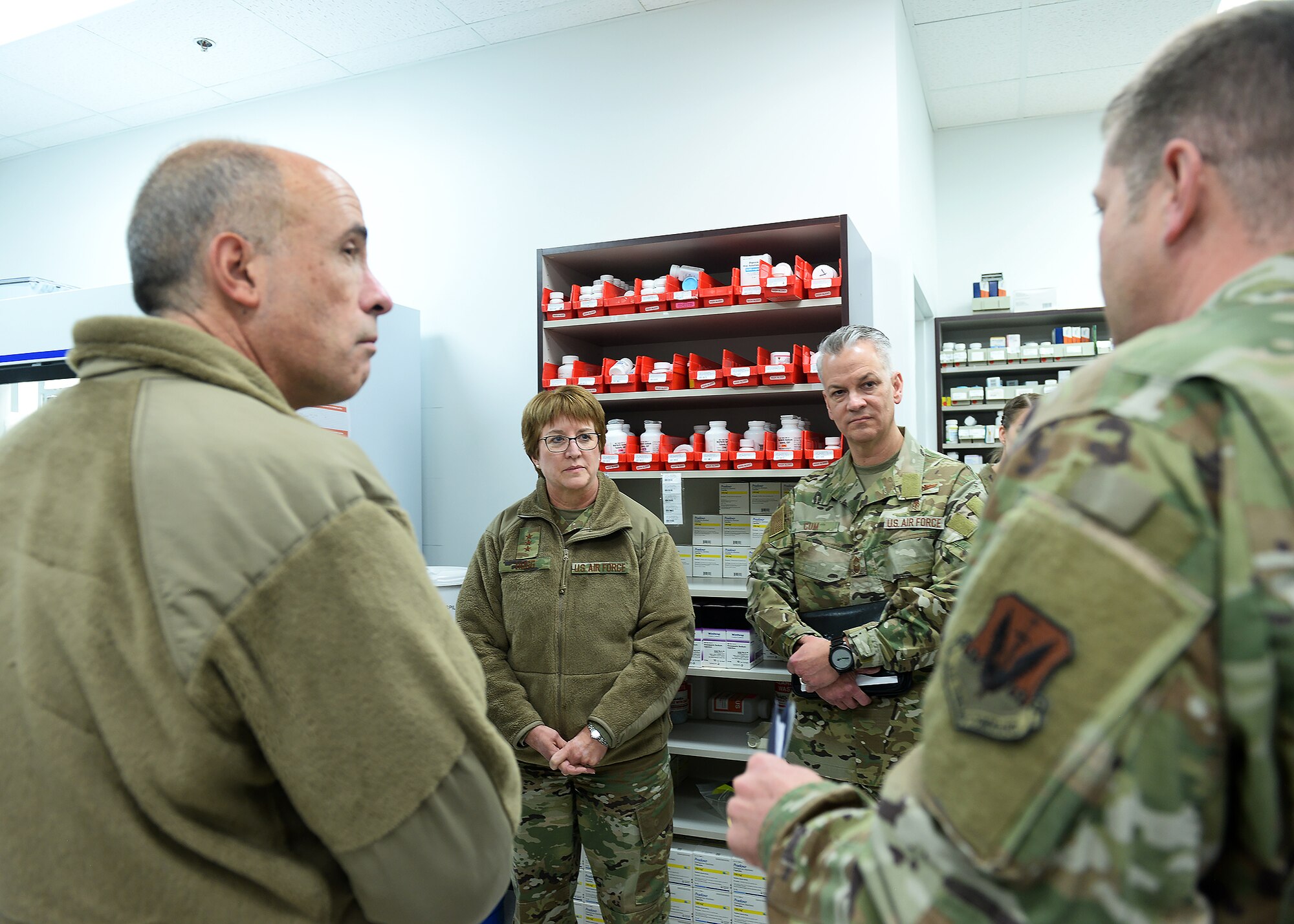 Maj. Gen. Robert Miller, Director, Medical Operations and Research, Office of the Surgeon General, Lt. Gen. Dorothy Hogg, Air Force Surgeon General, and Chief Master Sgt. Steve Cum, Chief, Medical Enlisted Force and Enlisted Corps Chief, Office of the Surgeon General, listens to Lt. Col. James Smiths, 55th Medical Group, describe the changes the satellite pharmacy made to adapt to the needs of their patients during their visit to Offutt Air Force Base, Nebraska.