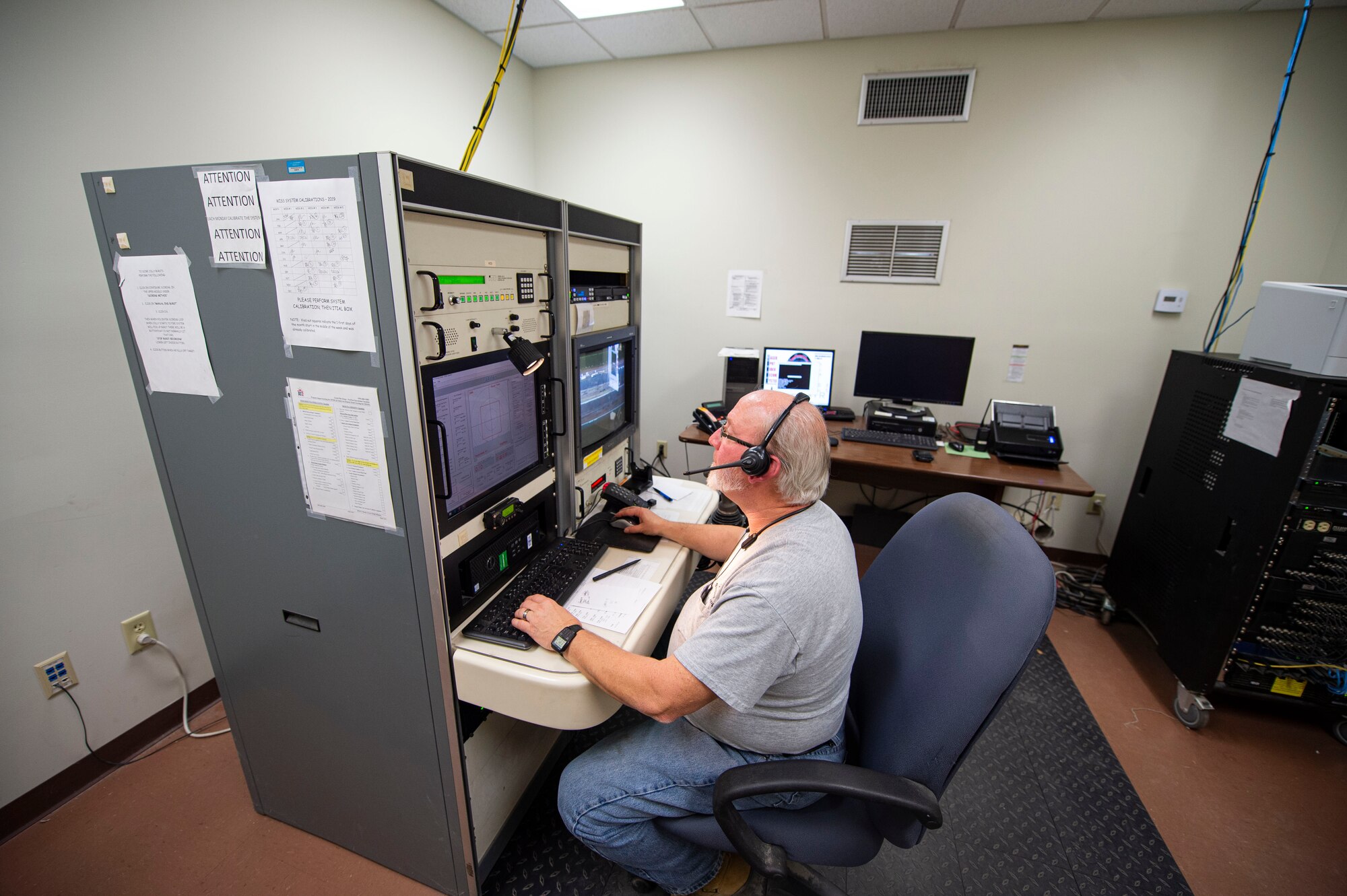 Photo of an Airman working on a scoring system.