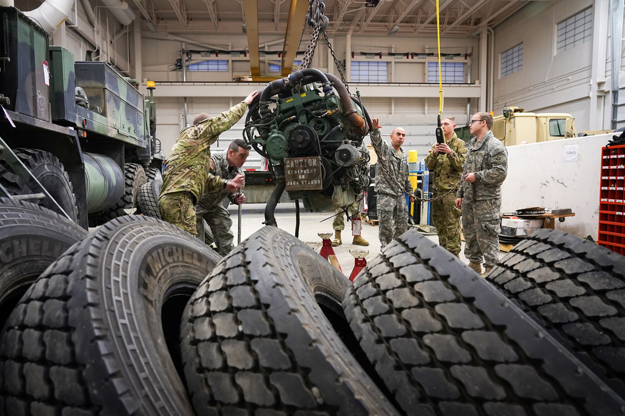 Soldiers assigned to the 109th Transportation Company, 17th Combat Sustainment Support Battalion, U.S. Army Alaska, remove a damaged engine from an M984A2 Heavy Expanded Mobility Tactical Truck wrecker in their motor pool on Joint Base Elmendorf-Richardson, Alaska, Dec. 13, 2019. The M984A2 is an eight-wheel drive, diesel-powered, variant of the HEMTT used in vehicle recovery operations.