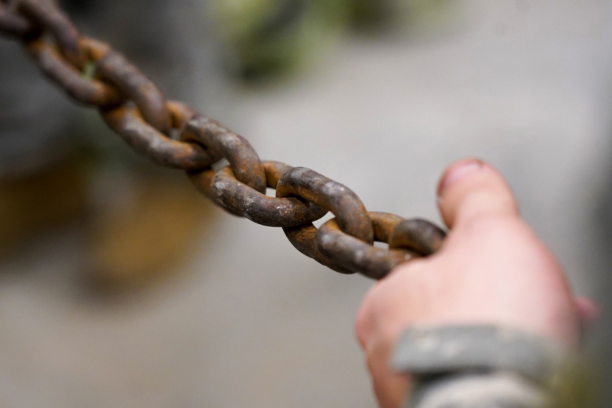 A soldier assigned to the 109th Transportation Company, 17th Combat Sustainment Support Battalion, U.S. Army Alaska, holds a chain to steady a damaged engine from an M984A2 Heavy Expanded Mobility Tactical Truck wrecker as it’s hoisted onto jack stands in his unit’s motor pool on Joint Base Elmendorf-Richardson, Alaska, Dec. 13, 2019. The M984A2 is an eight-wheel drive, diesel-powered, variant of the HEMTT used in vehicle recovery operations.