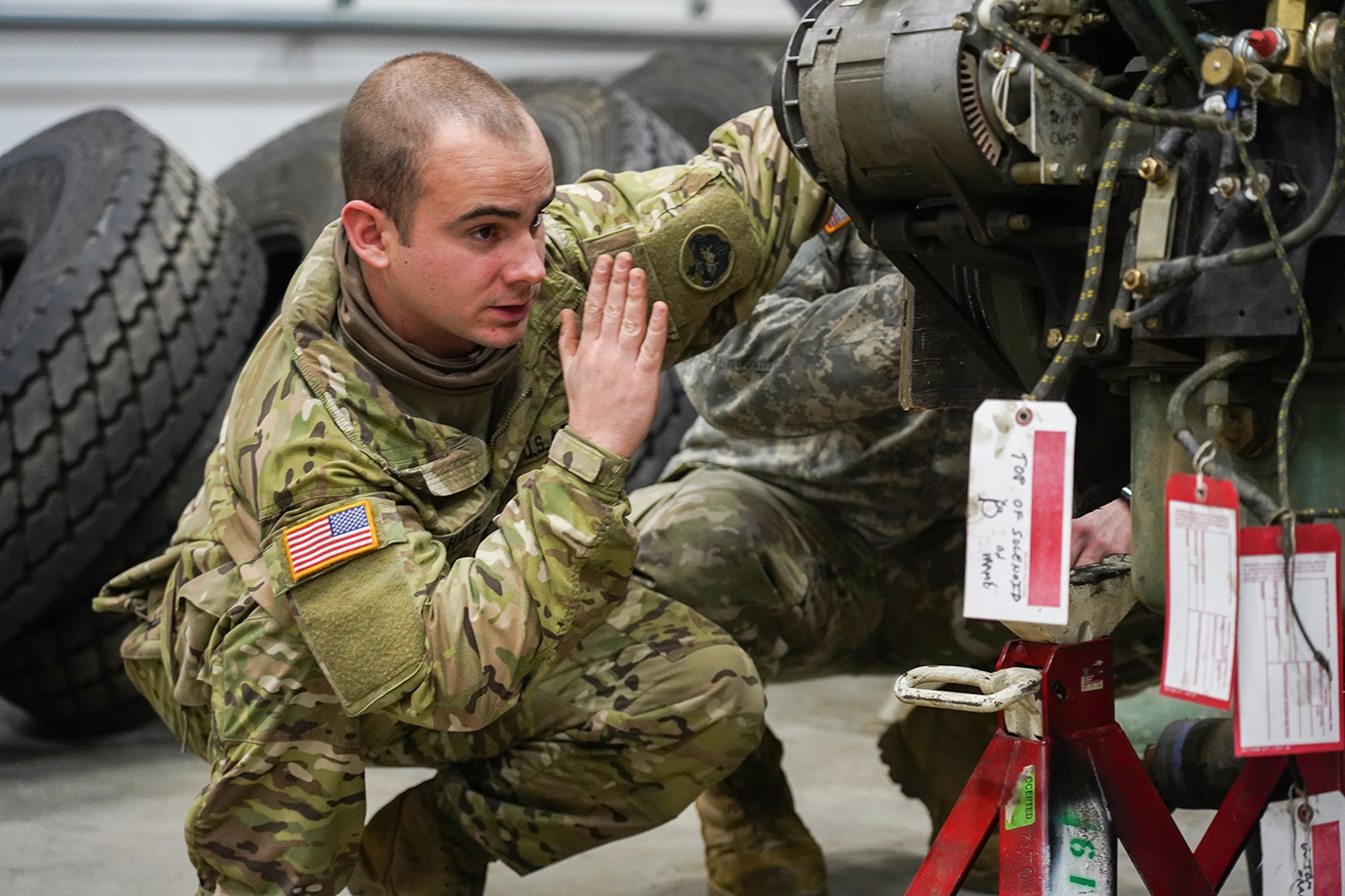 Army Sgt. Tyler Hale, a native of Wilmington, N.C., left, assigned to the 109th Transportation Company, 17th Combat Sustainment Support Battalion, U.S. Army Alaska, guides a damaged engine from an M984A2 Heavy Expanded Mobility Tactical Truck wrecker onto jack stands in his unit’s motor pool on Joint Base Elmendorf-Richardson, Alaska, Dec. 13, 2019. The M984A2 is an eight-wheel drive, diesel-powered, variant of the HEMTT used in vehicle recovery operations.