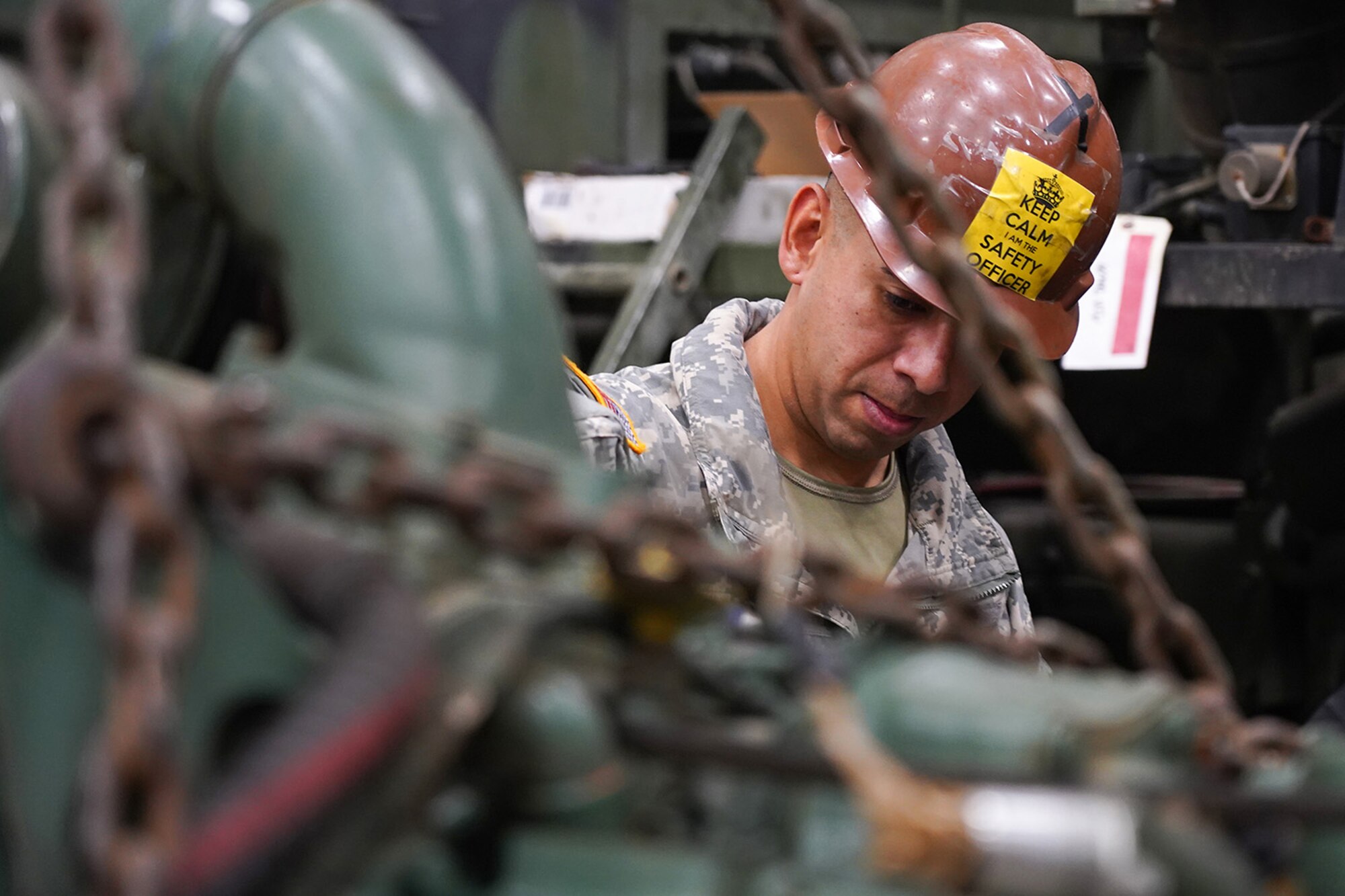 Army Staff Sgt. Federico Lazaro, a native of Chicago, assigned to the 109th Transportation Company, 17th Combat Sustainment Support Battalion, U.S. Army Alaska, supervises his Soldiers moving a damaged engine from an M984A2 Heavy Expanded Mobility Tactical Truck wrecker with a hoist in their motor pool on Joint Base Elmendorf-Richardson, Alaska, Dec. 13, 2019. The M984A2 is an eight-wheel drive, diesel-powered, variant of the HEMTT used in vehicle recovery operations.