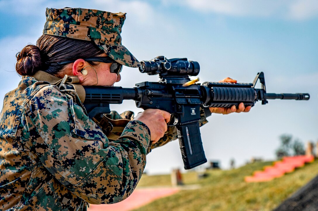 A Marine aims a weapon.