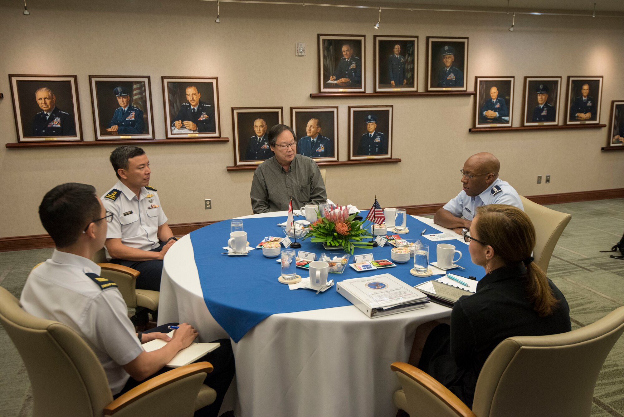 Gen. CQ Brown, Jr., Pacific Air Forces commander, conducts bilateral discussions with Maj. Gen. Kelvin Boon Leong Khong, Chief of Air Force, Republic of Singapore Air Force, Brian Woo, PACAF foreign policy adviser, and Kelli Seybolt, deputy under secretary of the Air Force for international affairs during the 2019 Pacific Air Chiefs Symposium at Joint Base Pearl Harbor-Hickam, Hawaii, Dec. 5, 2019.