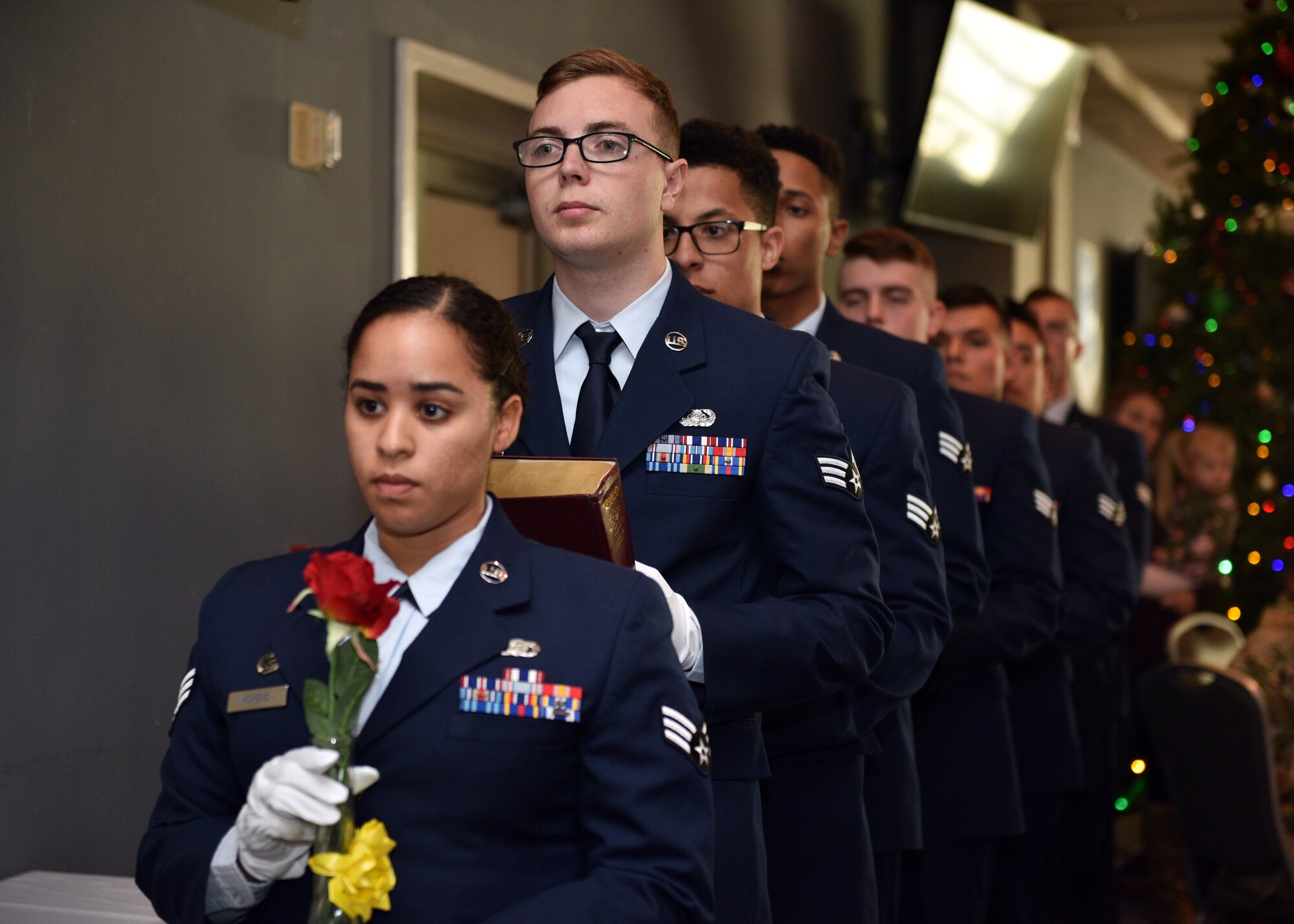 Graduates of Airman Leadership School Class 20-A prepare to set the POW/MIA table during the ALS Graduation ceremony at the event center on Goodfellow Air Force Base, Texas, December 12, 2019. The table was set as a symbol of honor and remembrance of America’s prisoners of war and missing comrades across all branches. (U.S. Air Force photo by Airman 1st Class Robyn Hunsinger)