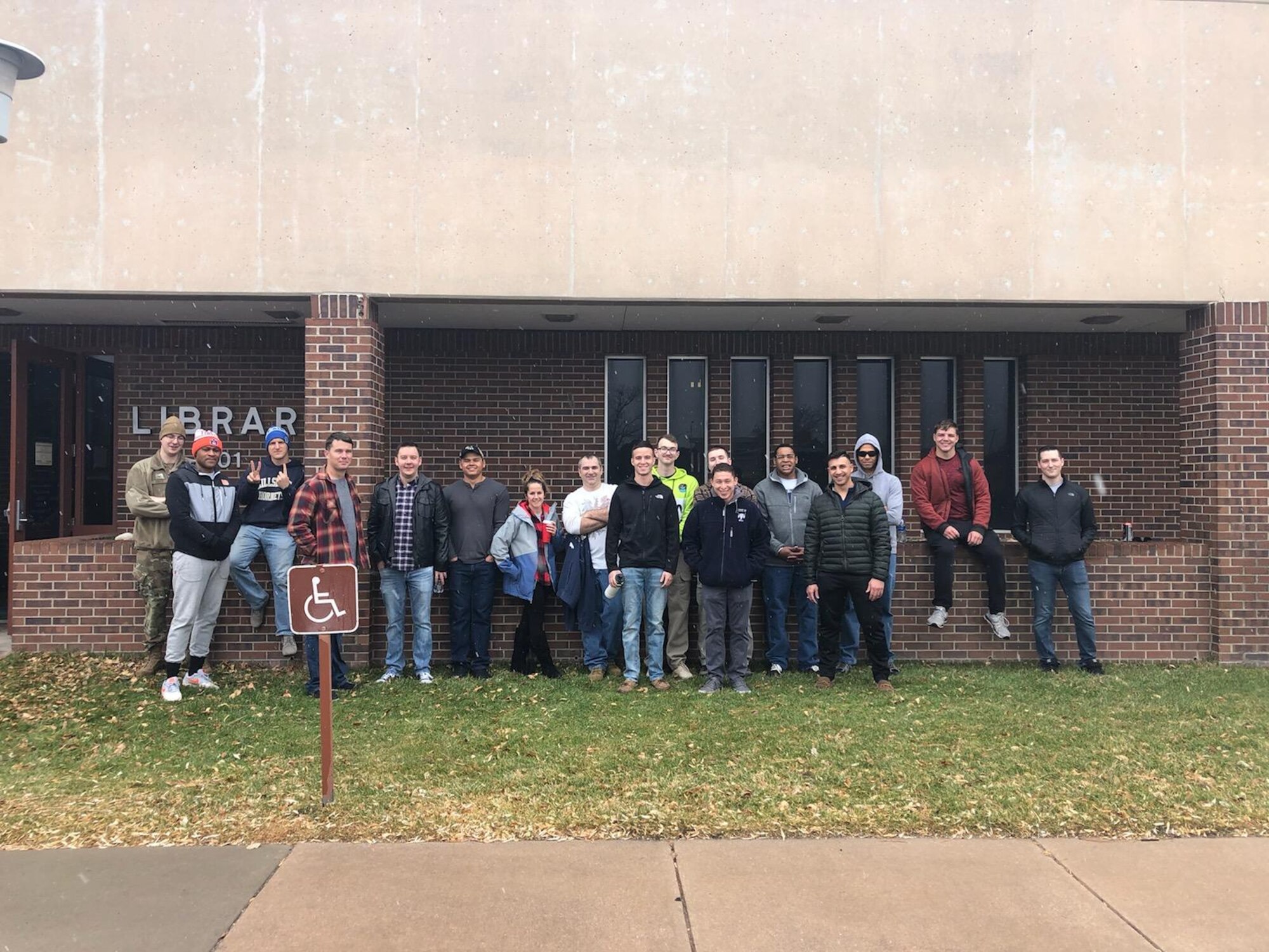 Members of the 21st Operations Support Squadron stand for a group photo after assisting base library staff in packing up the library on Peterson Air Force Base, Colorado for temporary closure Nov. 21, 2019. (U.S. Air Force courtesy photo)