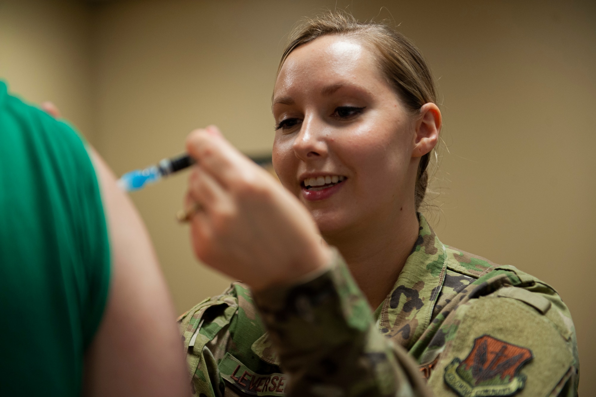 A photo of an Airman administering the flu shot