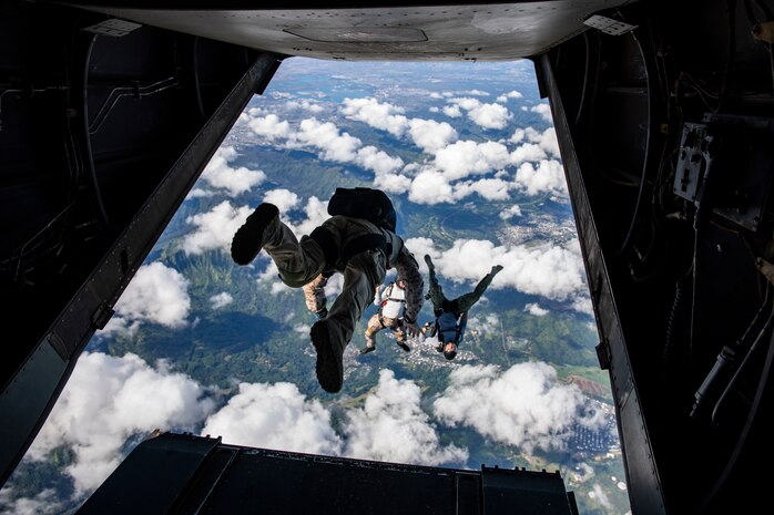 U.S. Service members jump out of an MV-22B Osprey assigned to Marine Medium tiltrotor Squadron during a parachute training operations, Marine Corps Training Area Bellows, Dec. 10, 2019. The joint training event served to ensure that U.S. Marines, Sailors, Soldiers, and Airmen maintained their yearly parachutist jump qualifications. (U.S. Marine Corps photo by Lance Cpl. Jose Angeles)