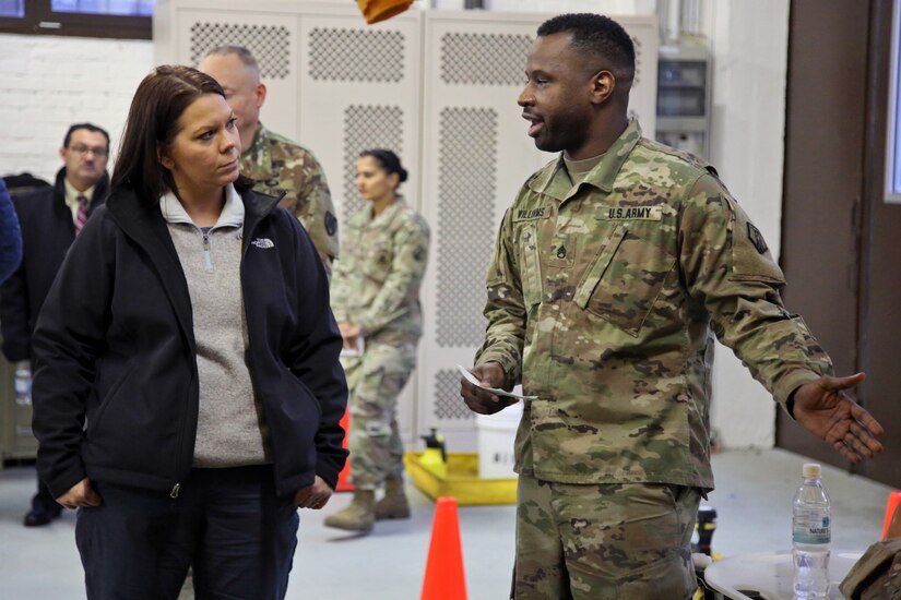 U.S. Army Reserve Staff Sgt. Antwon Williams, a human resources noncommissioned officer with the 773rd Civil Support Team, 7th Mission Support Command, explains decontamination capabilities to Dr. Brandi C. Vann, deputy assistant secretary of defense for U.S. Chemical and Biological Defense, while she tours the 773rd headquarters on Panzer Kaserne in Kaiserslautern, Germany, December 11, 2019. The 773rd is the only Civil Support Team in the U.S. Army Reserve and the European theater of operations. (U.S. Army Reserve photo by Sgt. 1st Class Joy Dulen)