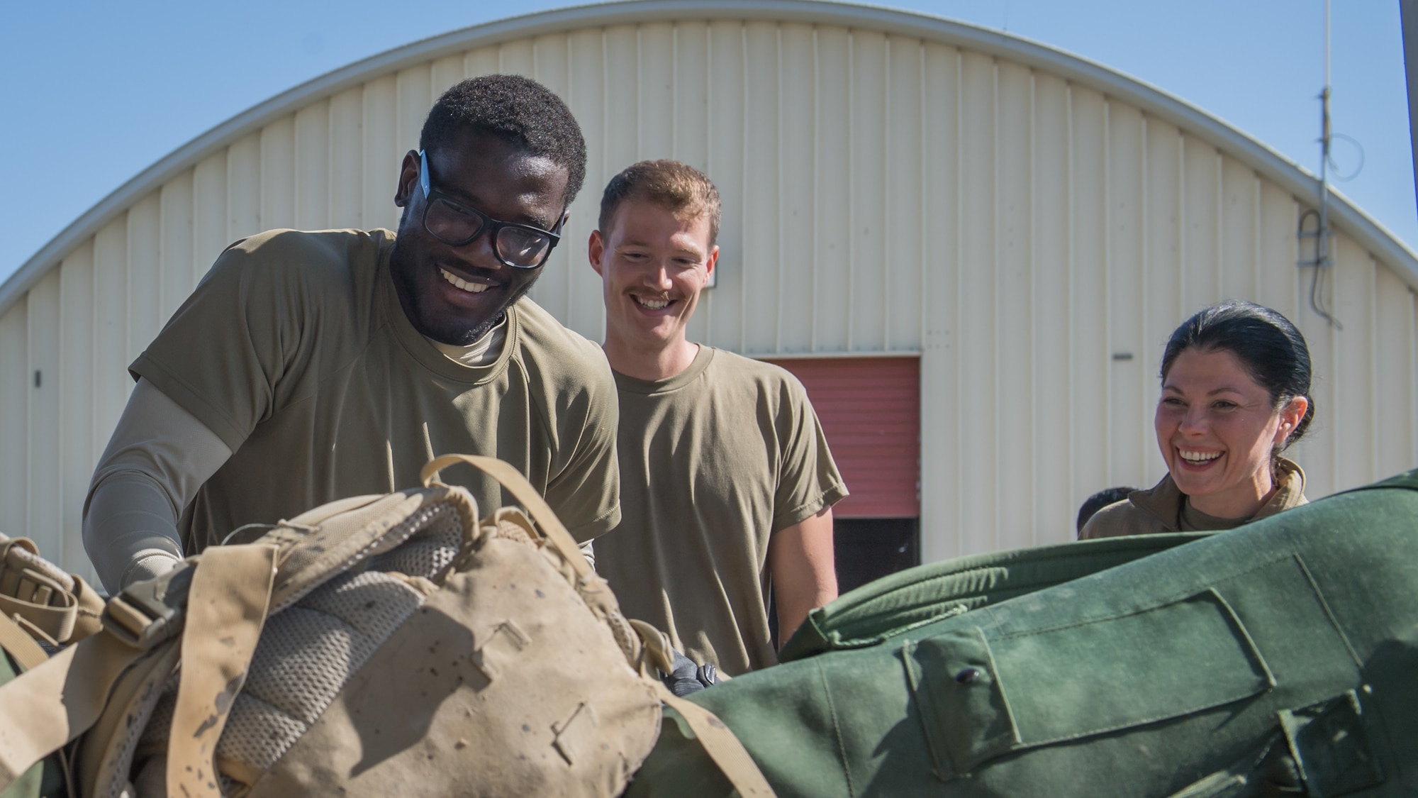Airmen 1st Class Mbianda Nkouambong and James Bullard and Senior Airman Candace Schmitz, all assigned to the 386th Expeditionary Logistics Readiness Squadron passenger terminal, stacks bags onto a pallet at Ali Al Salem Air Base, Kuwait, Nov. 21, 2019. Since July, passenger terminal Airmen have built more than 15,000 pallets for transport. (U.S. Air Force photo by Tech. Sgt. Daniel Martinez)