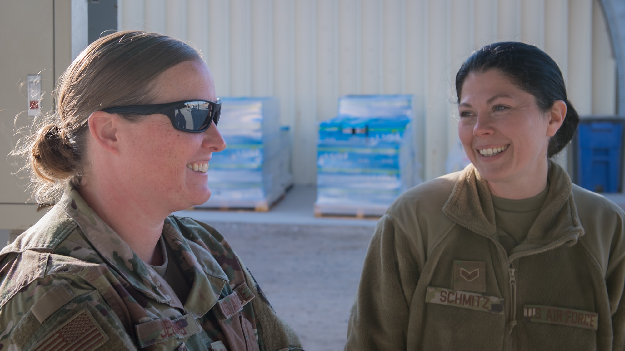 Tech. Sgt. Susan Jenkins, 386th Expeditionary Logistics Readiness Squadron NCO-in-charge of passenger operations, and Senior Airman Candace Schmitz, 386th ELRS air transportation specialist, share a lighter moment while at the pallet yard behind the passenger terminal at Ali Al Salem Air Base, Kuwait, Nov. 20, 2019. Since July, the passenger terminal flight has built more than 15,000 pallets for transport. (U.S. Air Force photo by Tech. Sgt. Daniel Martinez)