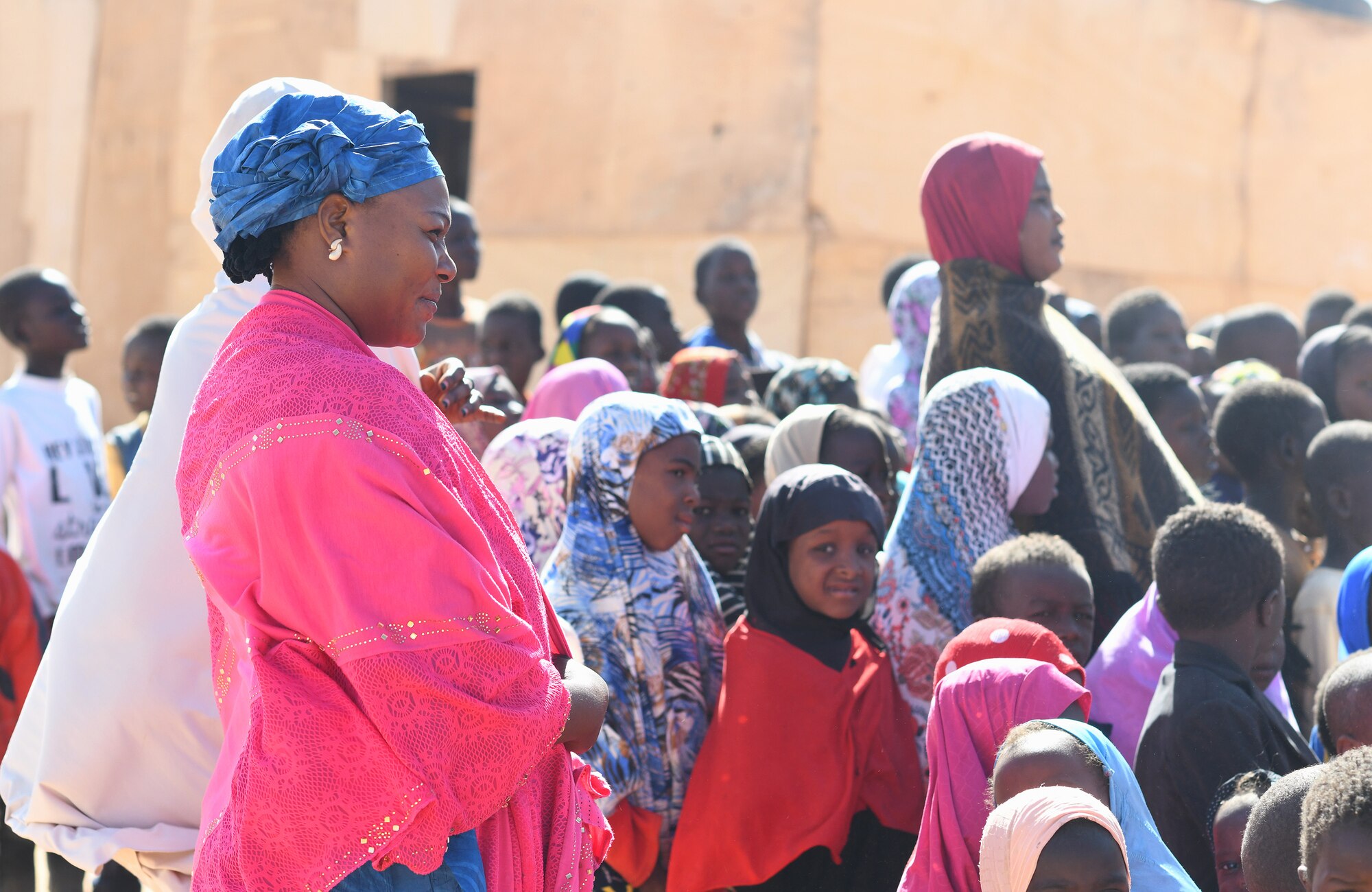Local teachers and students watch a dedication ceremony of their new classroom in the village of Tadress, Niger, Dec. 12, 2019. Coordinated by members of the U.S. Army 443rd Civil Affairs Battalion CAT 219, Airmen deployed to the 724th Expeditionary Air Base Squadron Civil Engineer Flight, Nigerien Air Base 201, constructed the new classroom for the students. In Niger, a teacher is only assigned to a class if there is a building to teach in. (U.S. Air Force photo by Staff Sgt. Alex Fox Echols III)
