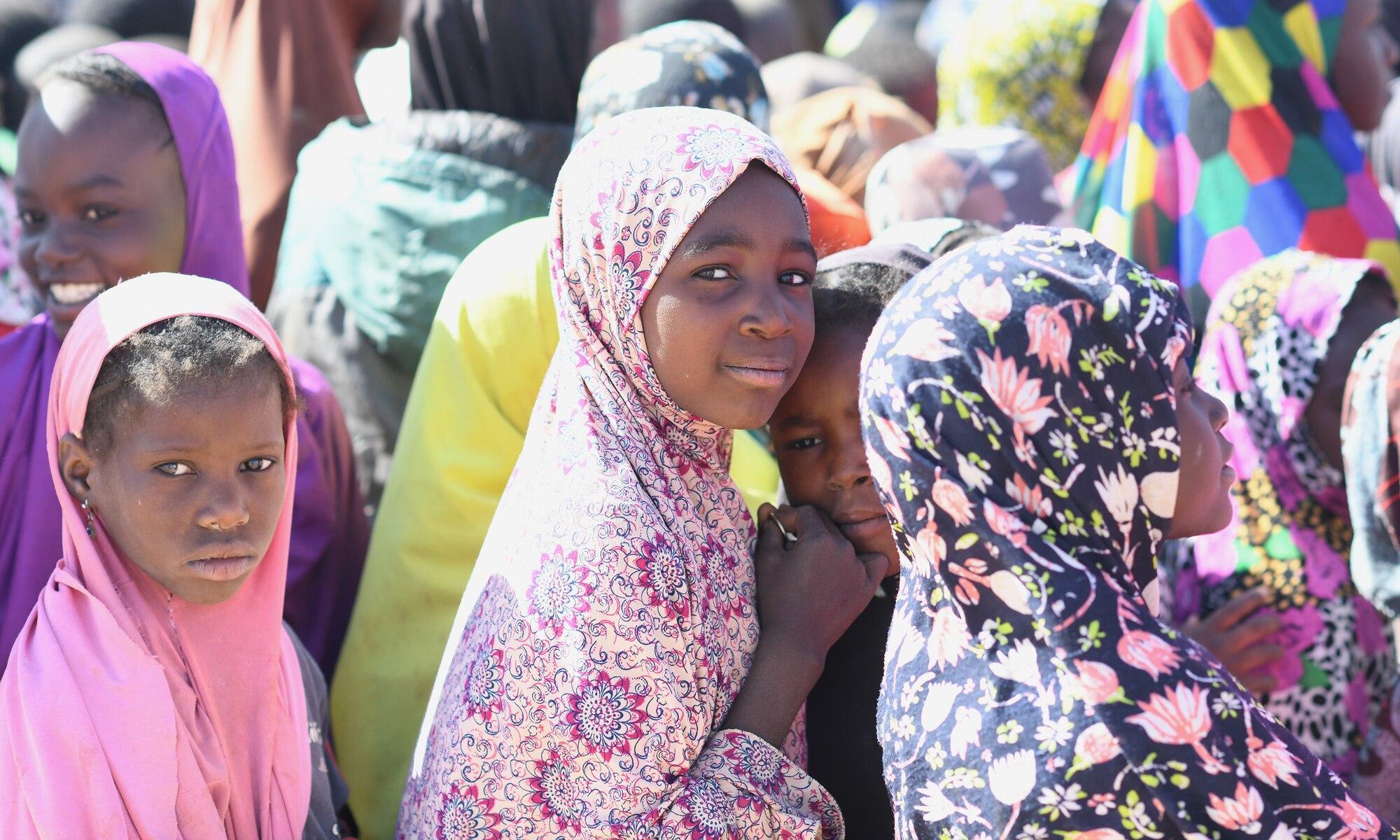 School children gather during a dedication ceremony of their new classroom in the village of Tadress, Niger, Dec. 12, 2019. Coordinated by members of the U.S. Army 443rd Civil Affairs Battalion CAT 219, Airmen deployed to the 724th Expeditionary Air Base Squadron Civil Engineer Flight, Nigerien Air Base 201, constructed the new classroom for the students. In Niger, a teacher is only assigned to a class if there is a building to teach in. (U.S. Air Force photo by Staff Sgt. Alex Fox Echols III)