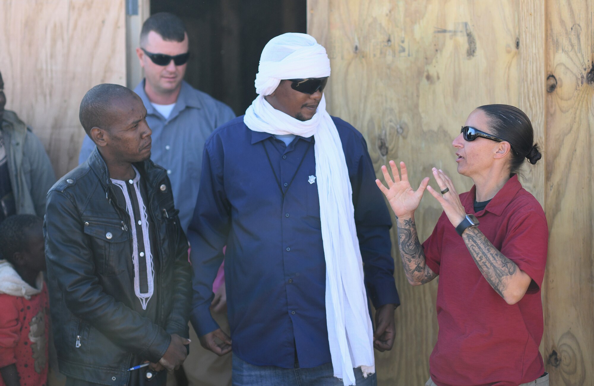 U.S. Army Capt. AnnaMarie Verdura, 443rd Civil Affairs Battalion CAT 219 team leader, speaks to a village elder during a dedication ceremony of a new classroom in the village of Tadress, Niger, Dec. 12, 2019. Coordinated by members of the U.S. Army 443rd Civil Affairs Battalion CAT 219, Airmen deployed to the 724th Expeditionary Air Base Squadron Civil Engineer Flight, Nigerien Air Base 201, constructed the new classroom for the students. In Niger, a teacher is only assigned to a class if there is a building to teach in. (U.S. Air Force photo by Staff Sgt. Alex Fox Echols III)