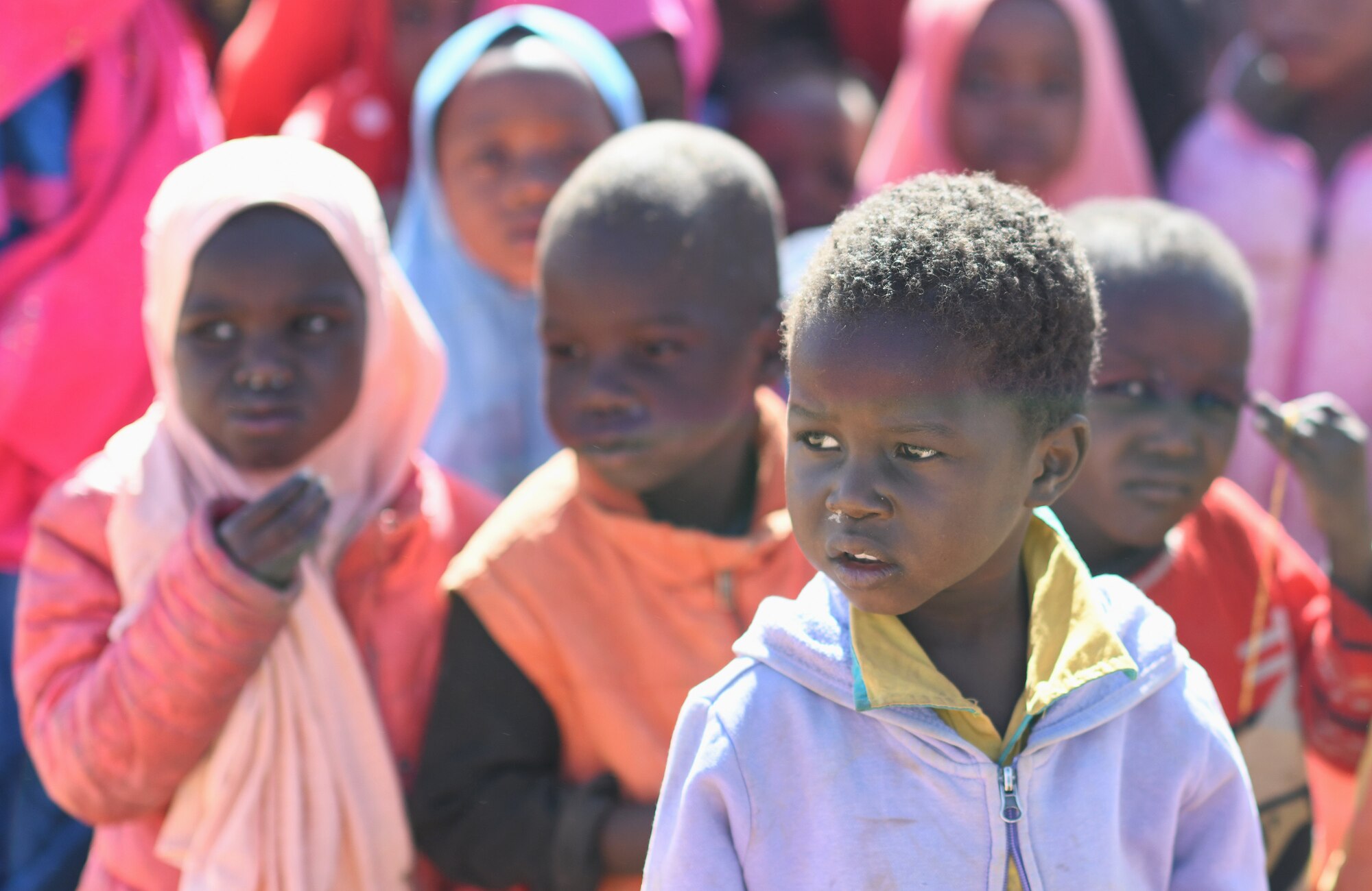 School children gather during a dedication ceremony of their new classroom in the village of Tadress, Niger, Dec. 12, 2019. Coordinated by members of the U.S. Army 443rd Civil Affairs Battalion CAT 219, Airmen deployed to the 724th Expeditionary Air Base Squadron Civil Engineer Flight, Nigerien Air Base 201, constructed the new classroom for the students. In Niger, a teacher is only assigned to a class if there is a building to teach in. (U.S. Air Force photo by Staff Sgt. Alex Fox Echols III)