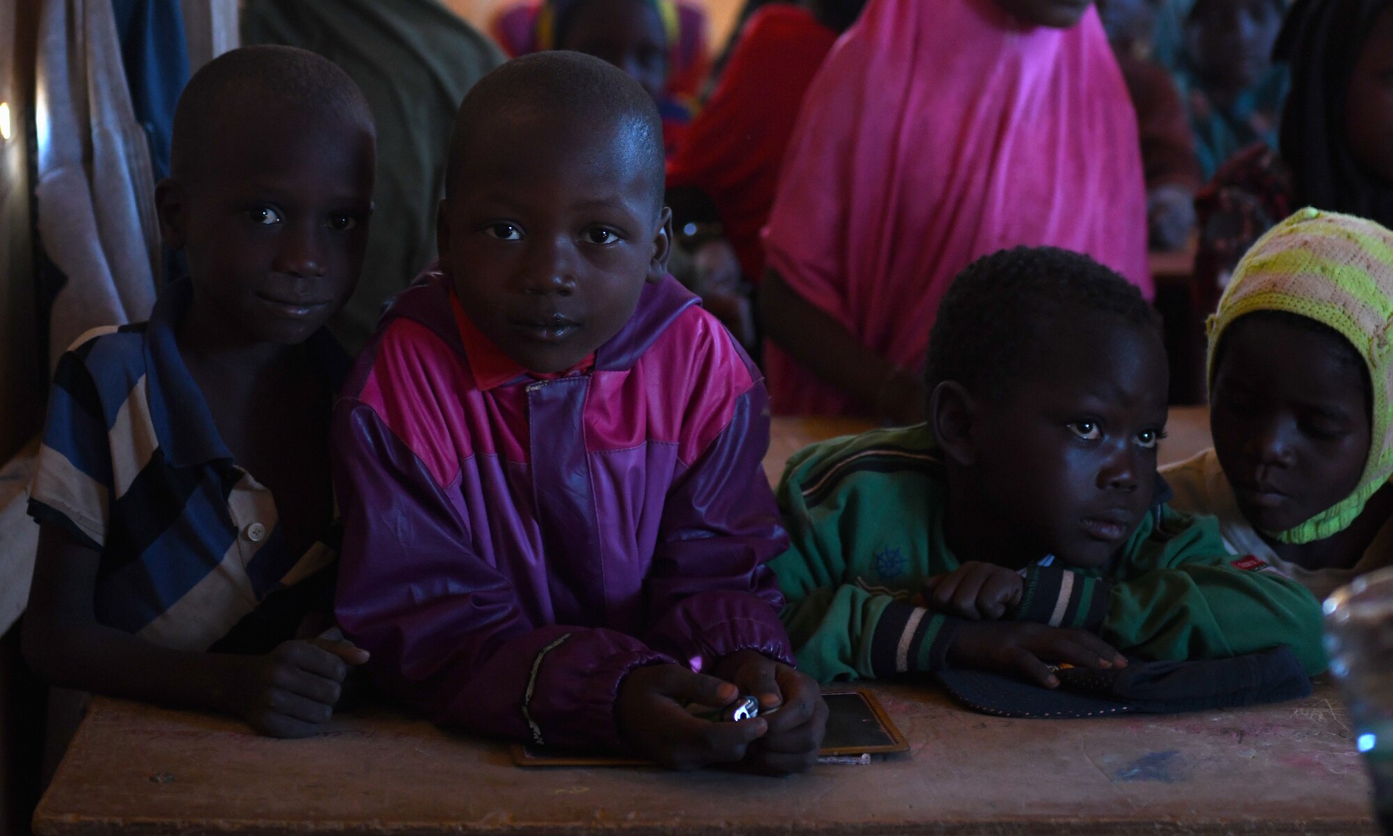 School children sit inside an older classroom in the village of Tadress, Niger, Dec. 12, 2019. Coordinated by members of the U.S. Army 443rd Civil Affairs Battalion CAT 219, Airmen deployed to the 724th Expeditionary Air Base Squadron Civil Engineer Flight, Nigerien Air Base 201, constructed a new classroom for the students. In Niger, a teacher is only assigned to a class if there is a building to teach in. (U.S. Air Force photo by Staff Sgt. Alex Fox Echols III)