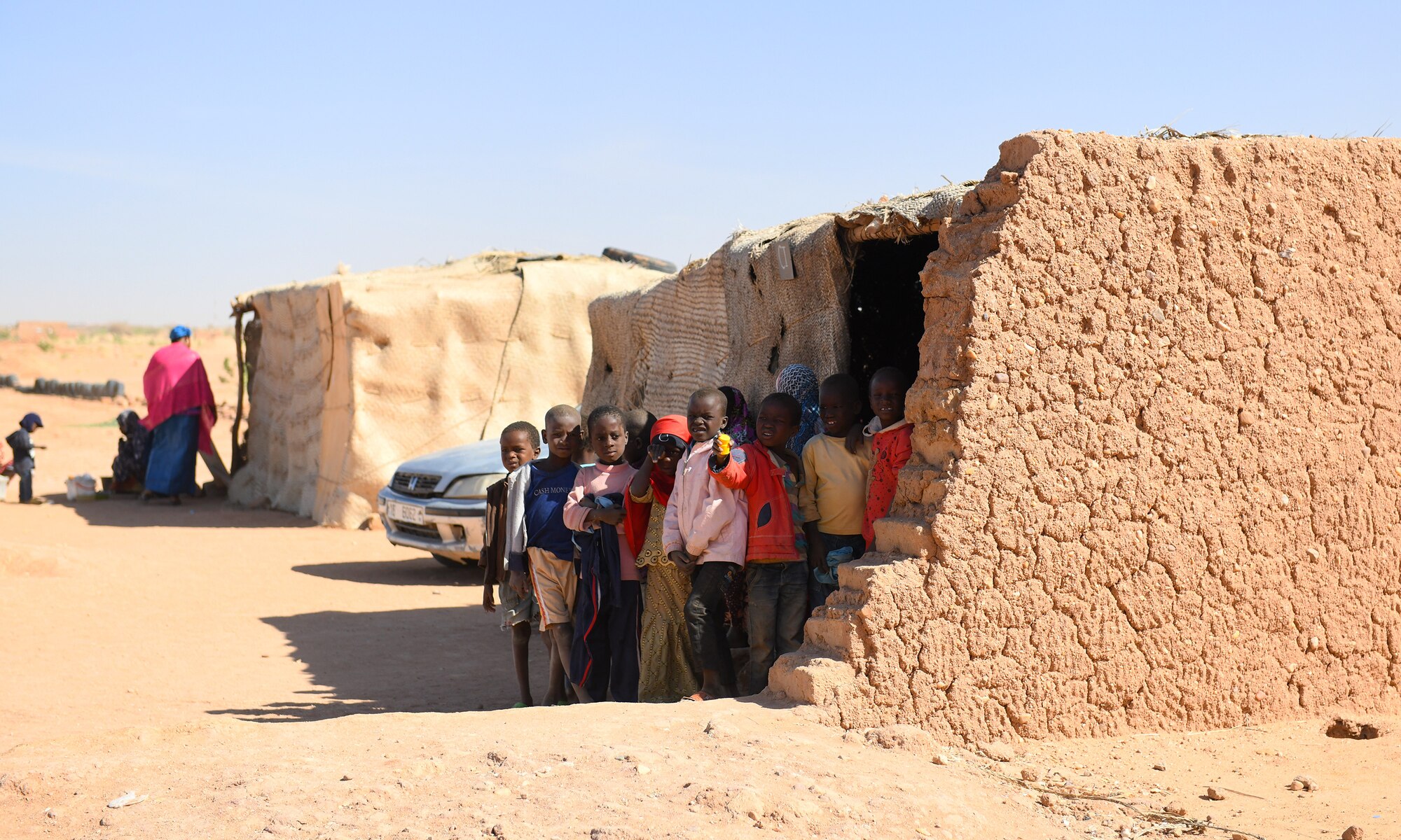 School children stand outside an older classroom in the village of Tadress, Niger, Dec. 12, 2019. Coordinated by members of the U.S. Army 443rd Civil Affairs Battalion CAT 219, Airmen deployed to the 724th Expeditionary Air Base Squadron Civil Engineer Flight, Nigerien Air Base 201, constructed a new classroom for the students. In Niger, a teacher is only assigned to a class if there is a building to teach in. (U.S. Air Force photo by Staff Sgt. Alex Fox Echols III)