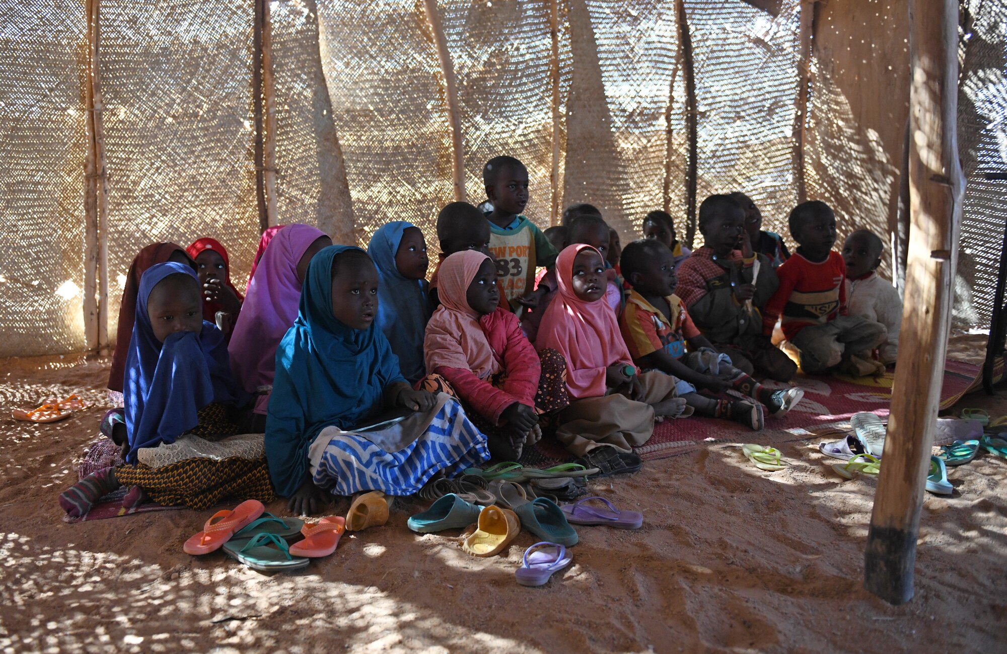 School children sit an older classroom in the village of Tadress, Niger, Dec. 12, 2019. Coordinated by members of the U.S. Army 443rd Civil Affairs Battalion CAT 219, Airmen deployed to the 724th Expeditionary Air Base Squadron Civil Engineer Flight, Nigerien Air Base 201, constructed a new classroom for the students. In Niger, a teacher is only assigned to a class if there is a building to teach in. (U.S. Air Force photo by Staff Sgt. Alex Fox Echols III)