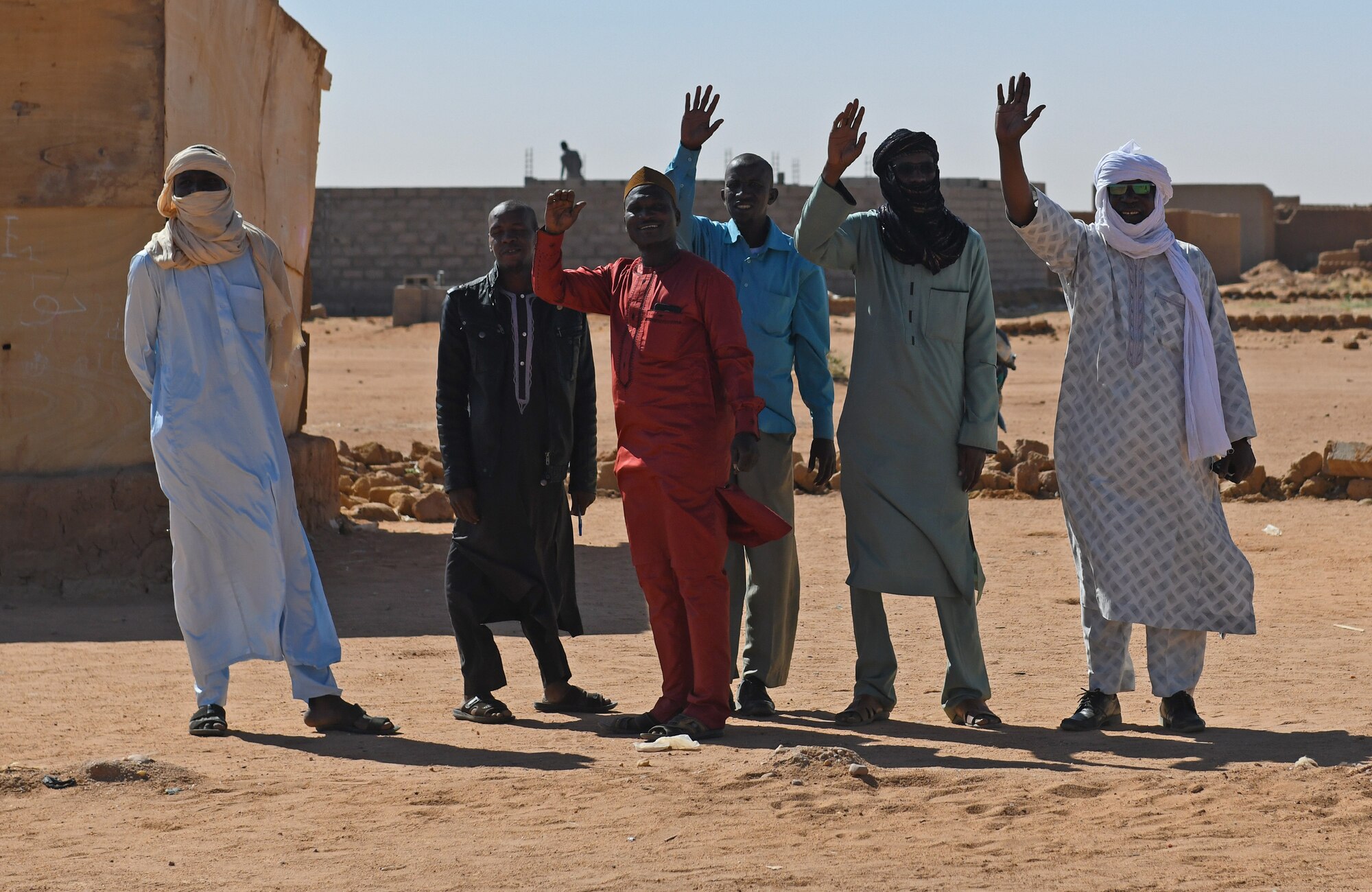 Village elders wave goodbye after the dedication ceremony of a new classroom in the village of Tadress, Niger, Dec. 12, 2019. Coordinated by members of the U.S. Army 443rd Civil Affairs Battalion CAT 219, Airmen deployed to the 724th Expeditionary Air Base Squadron Civil Engineer Flight, Nigerien Air Base 201, constructed the new classroom for the students. In Niger, a teacher is only assigned to a class if there is a building to teach in. (U.S. Air Force photo by Staff Sgt. Alex Fox Echols III)