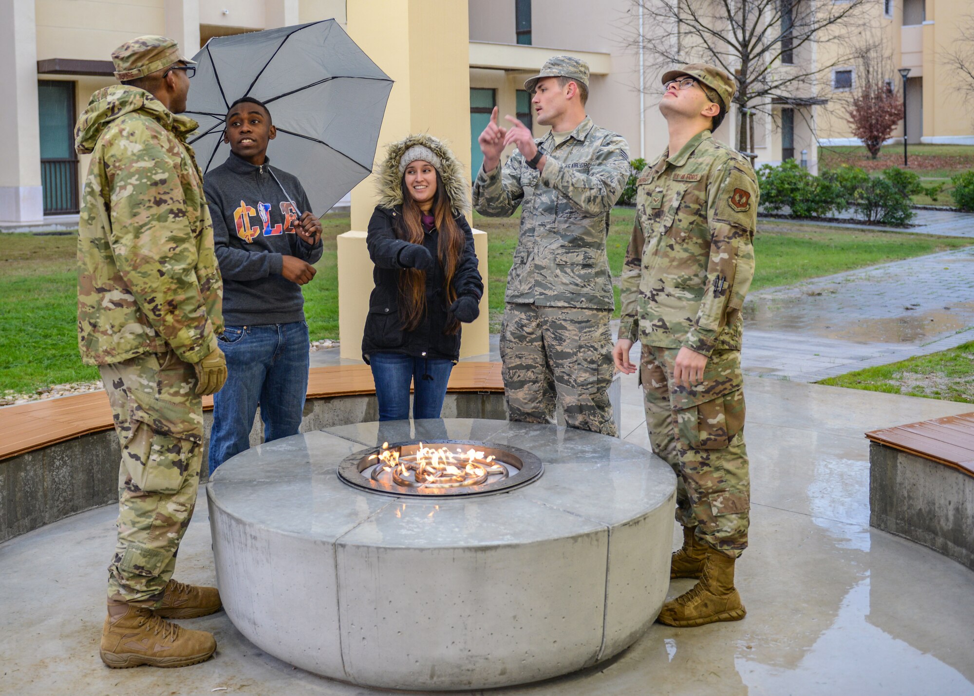 U.S. Air Force Airmen from the 31st Fighter Wing linger around a fire pit attached to a new dorm pavilion at Aviano Air Base, Italy, Dec. 13, 2019. The new pavilion will serve as a community focal point for Airmen to hang out and have a good time. (U.S. Air Force photo by Airman Thomas S. Keisler IV)