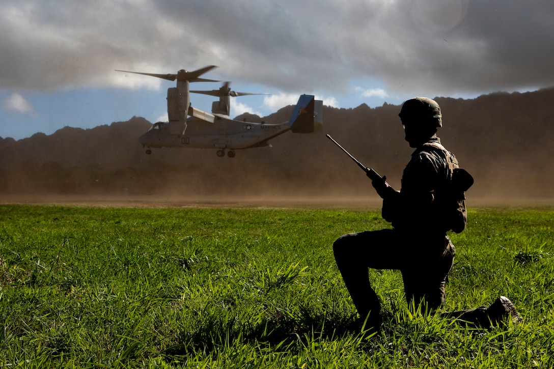 A U.S. Marine with Headquarters Battalion (HQBN), Marine Corps Base Hawaii (MCBH), holds a radio, Marine Corps Training Area, Bellows, Dec. 11, 2019. Marines with Headquarters Battalion, Marine Corps Base Hawaii executed 9-line transmissions, casualty response exercises, and casualty evacuations with the assistance of VMM-268 to increase their readiness.
