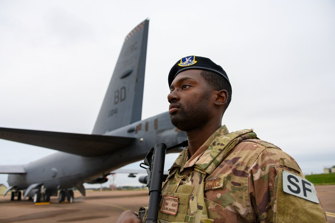 Photo of Staff Sgt. Michael Clark guarding a B-52 Stratofortress.