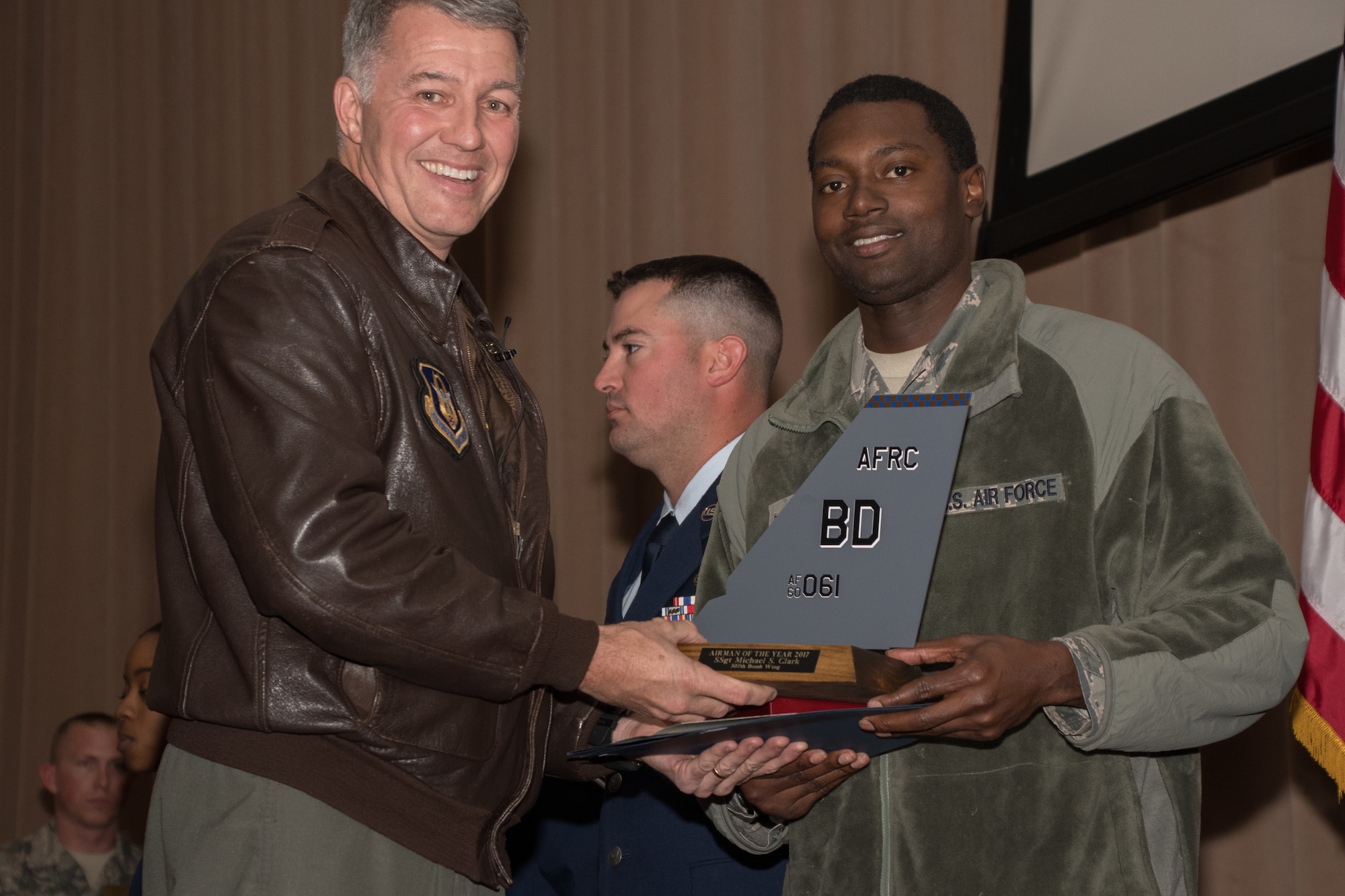 Photo of SSgt. Michael Clark accepting Airman of the Year award.