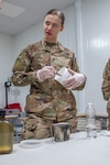 U.S. Army Spc. Shelby Vermeulen, with 1st Squadron, 303rd Cavalry Regiment, 96th Troop Command, Washington Army National Guard, works through the steps of water purification during a Field Sanitation Team Certification Course Dec. 9-13, 2019, at Joint Training Center-Jordan.