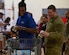 Andrew Council, Virginia Peninsula Foodbank product manager, and U.S. Army Pfc. Daniel Smith, 331st Transportation Company, 11th Battalion, 7th Transportation Brigade allied trade specialist, put groceries in a cart during a holiday food distribution at Joint Base Langley-Eustis, Virginia, Dec. 11, 2019.