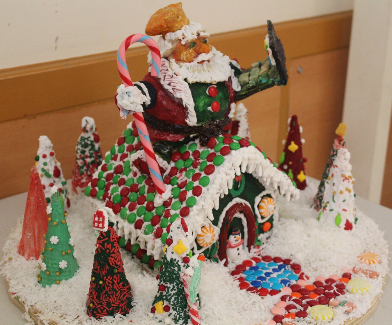 A winter scene depicted with a gingerbread house.