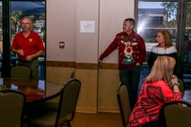 Craig Sproul, the district readiness coordinator and family readiness trainer, speaks to Marines and their families during the 6th Marine Corps District holiday dinner party at Marine Corps Air Station Beaufort, South Carolina, Dec. 14, 2019. The dinner party included a “meet Santa” display, dessert competition, and piñatas. . (U.S. Marine Corps photo by Sgt. Jorge A. Rosales)
