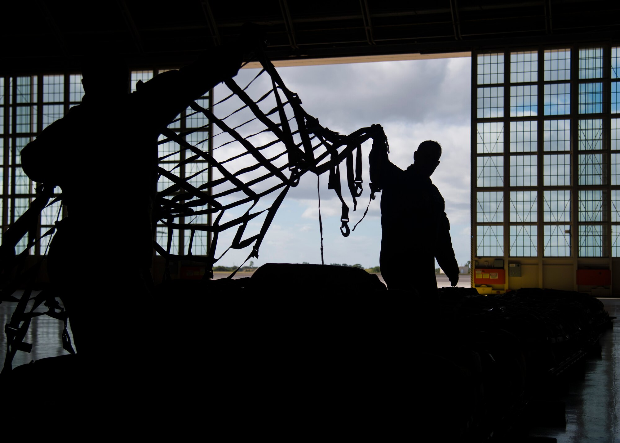 Members of the 6th Operations Group stretch a cargo net over a pallet of equipment in preparation for a 91st Air Refueling Squadron (ARS) deployment, Dec. 2, 2019 at MacDill Air Force Base, Fla.