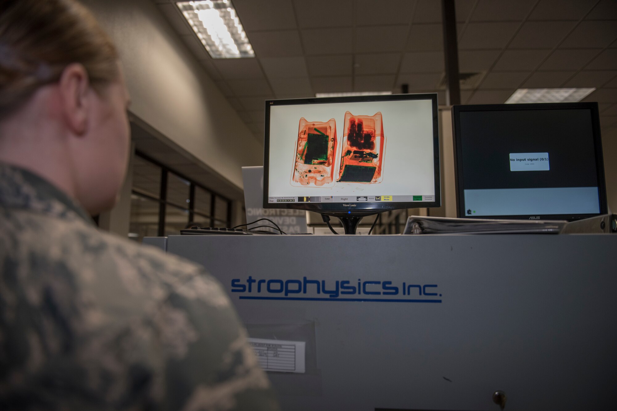 U.S. Air Force Airman 1st Class Hunter Gable, 60th Aerial Port Squadron air transportation agent, scans passengers’ bags for unauthorized items Dec. 6, 2019, at Travis Air Force Base, California. Gable had passengers put their bags in an X-ray machine before they were allowed to process through security. (U.S. Air Force photo by Airman 1st Class Cameron Otte)