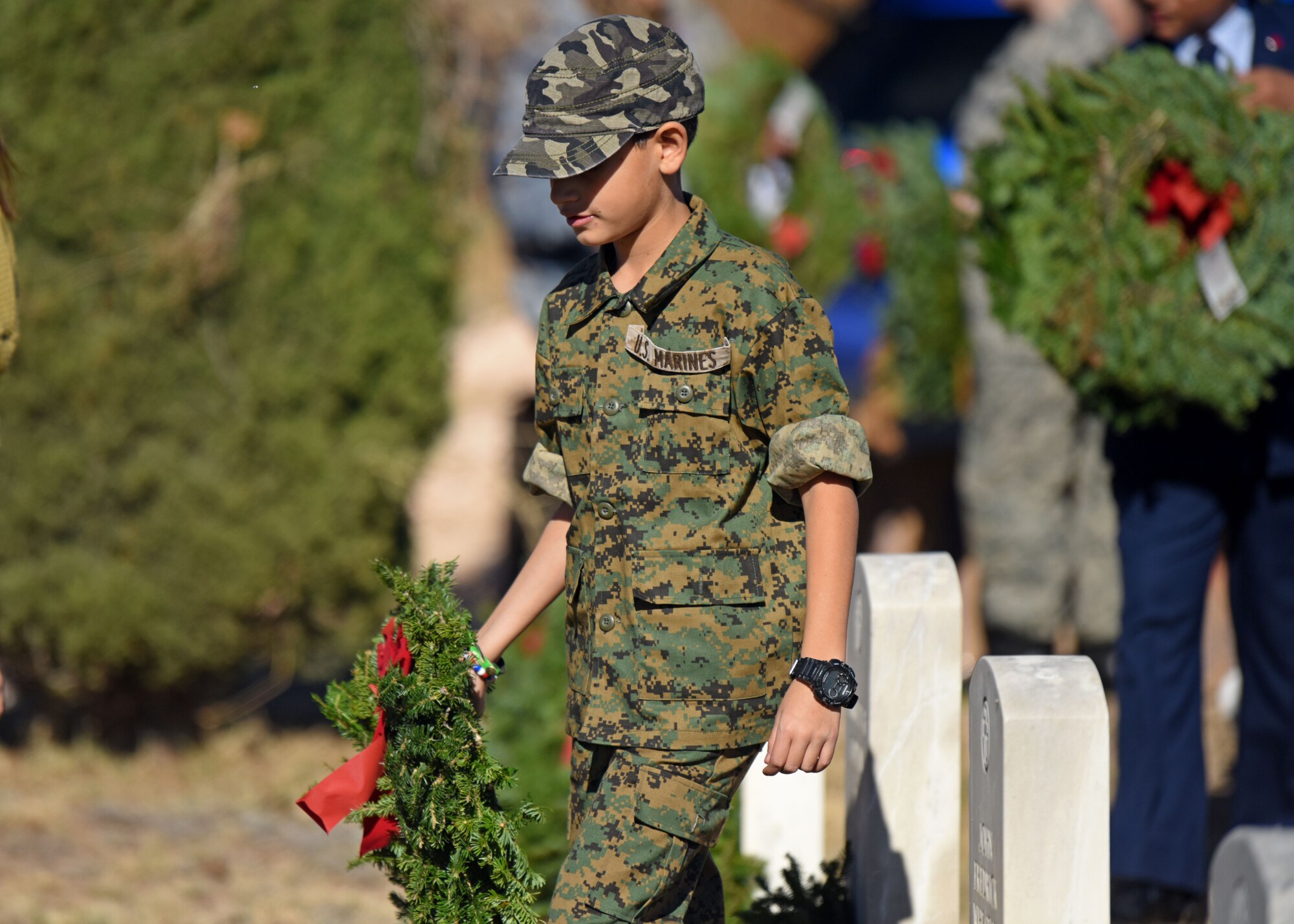 A citizen of San Angelo carries a wreath to place it at the foot of a veteran’s grave during Wreaths Across America at Belvedere Memorial Park Cemetery in San Angelo, Texas, Dec. 14, 2019. Wreaths Across America’s mission is to remember, honor and teach by coordinating wreath-laying ceremonies at Arlington National Cemetery as well as at more than 1,600 additional locations in all 50 states, at sea and abroad. (U.S. Air Force photo by Airman 1st Class Ethan Sherwood)