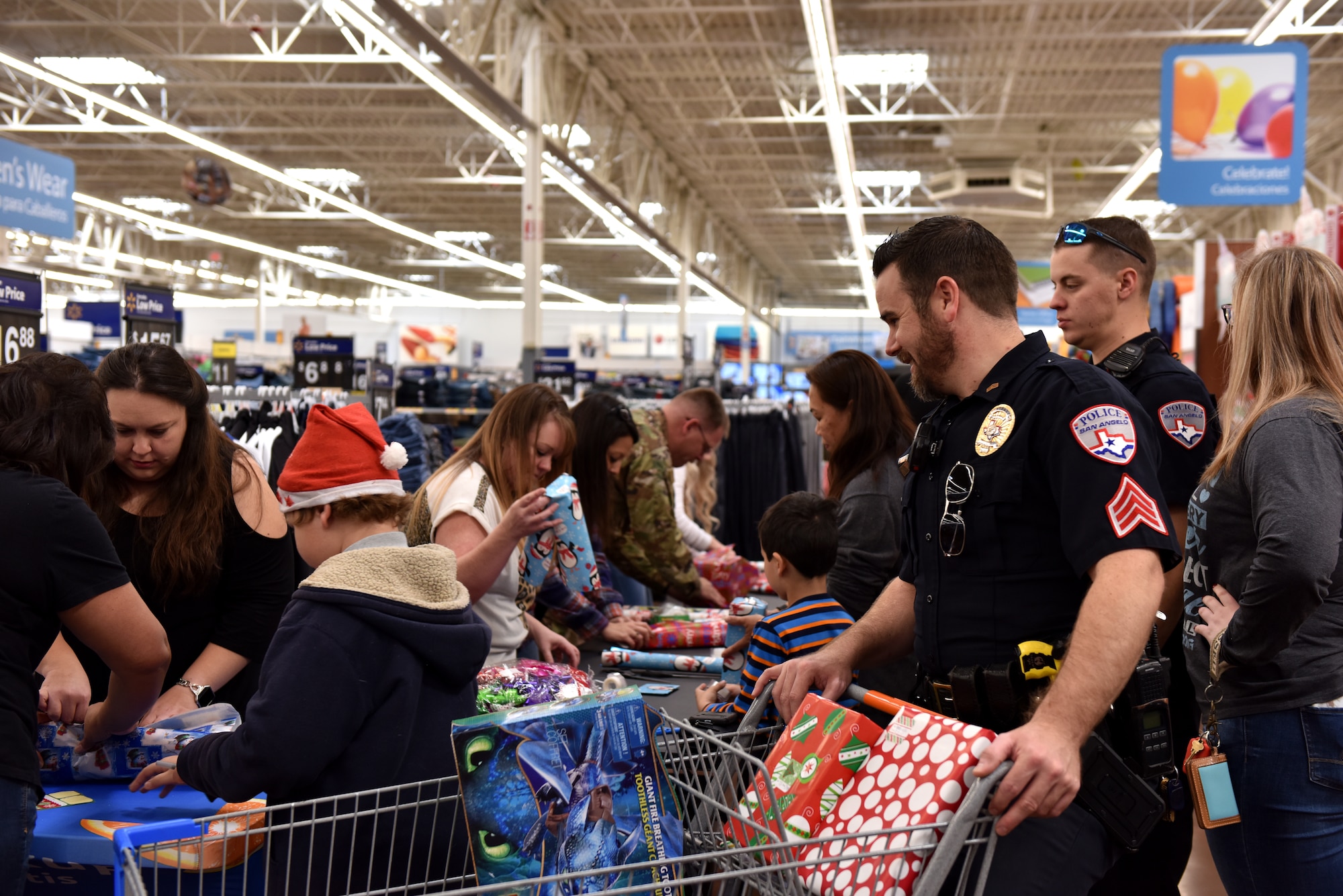 Volunteers wrap gifts purchased during the Operation Blue Santa Shop with a Cop event in San Angelo, Texas, Dec. 14, 2019. Refreshments were provided for the volunteers and participants at the event. (U.S. Air Force photo by Senior Airman Seraiah Wolf)