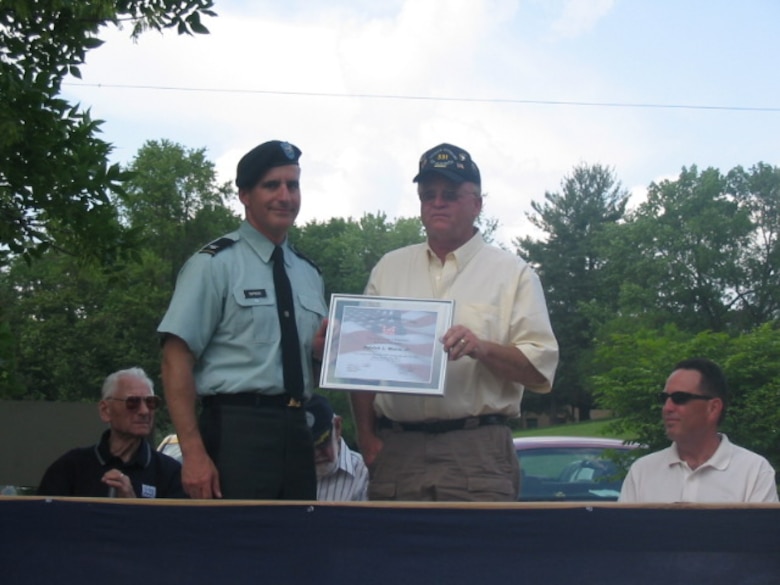 Patrick L. Moore, Jr. receives a certificate as his name is added to the Veterans Trail at Coralville Lake.