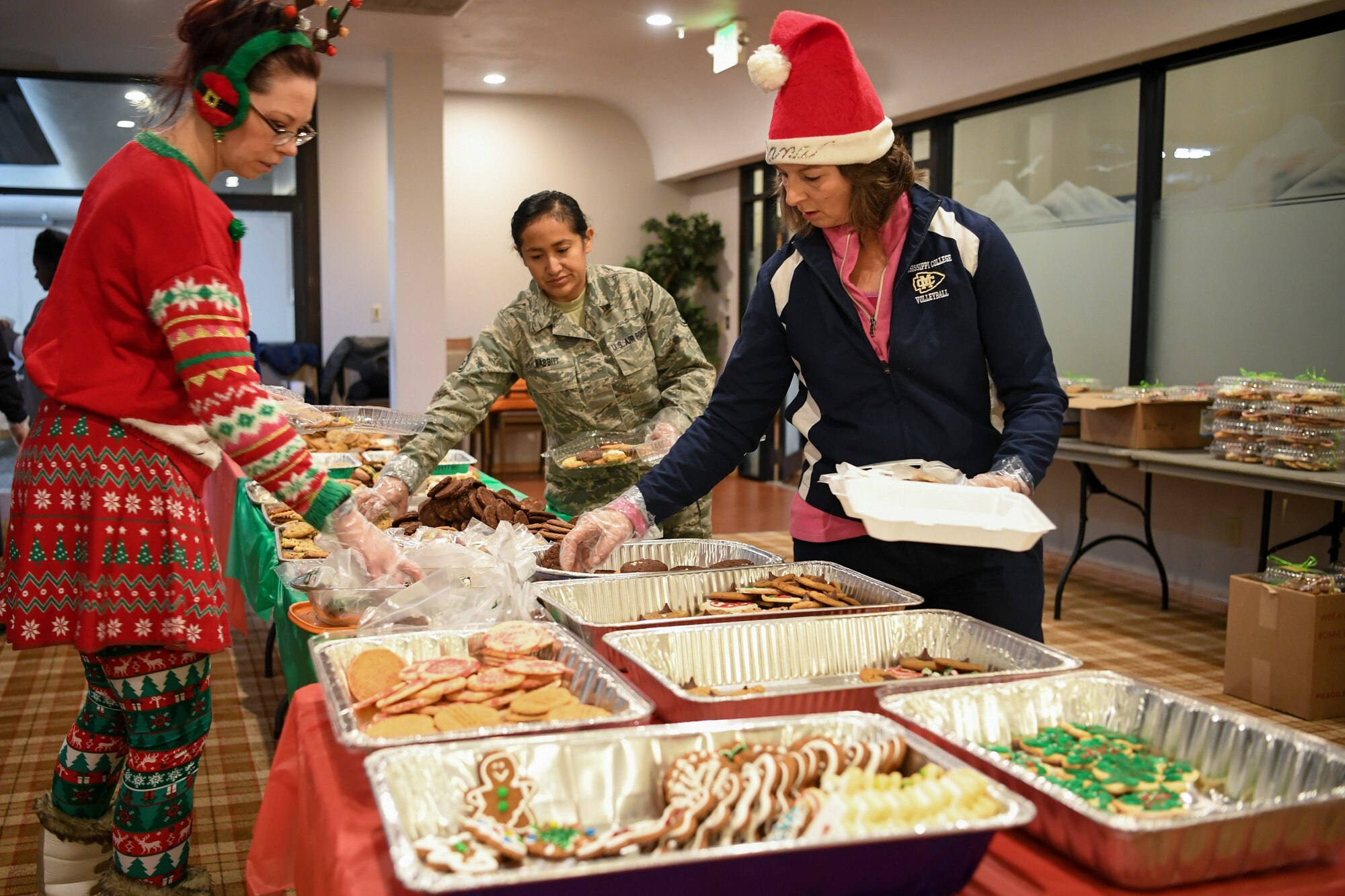 (Left to right) Aurora Koftinow, 75th Force Support Squadron, Staff Sgt. Diana Babbitt, 84th Radar Evaluation Squadron, and volunteer Dana Torick pack up holiday cookies destined for various Airmen across Hill Air Force Base, Utah, Dec. 16, 2019, during the annual Team Hill Airman Cookie Drive. Every year, volunteers bake, collect, package and deliver cookies to the base's Airmen. (U.S. Air Force photo by Cynthia Griggs)
