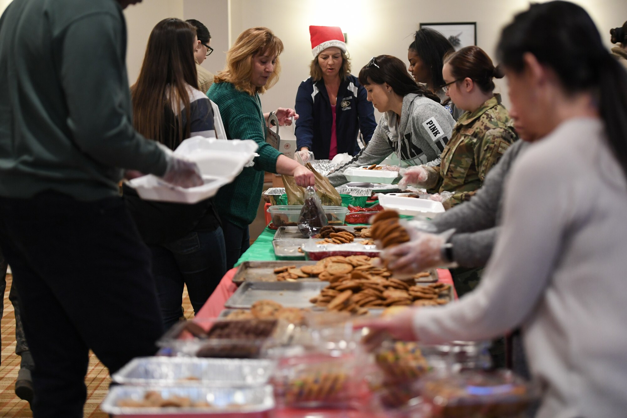 Volunteers pack up holiday cookies destined for various Airmen across Hill Air Force Base, Utah, Dec. 16, 2019, during the annual Team Hill Airmen Cookie Drive. Every year, volunteers bake, collect, package and deliver cookies to the base's Airmen. (U.S. Air Force photo by Cynthia Griggs)