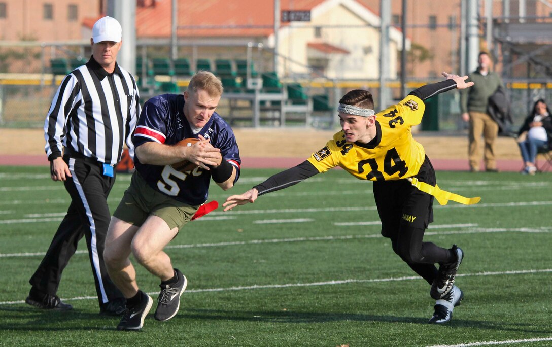 Marines, Sailors, and Soldiers competed om the Army vs. Navy flag football game aboard USAG Camp Humphreys 24 December. The teams played head to head for a trophy and bragging rights, while building comradery between services. (U.S. Marine Corps photo by Sgt. Parker R. Golz)