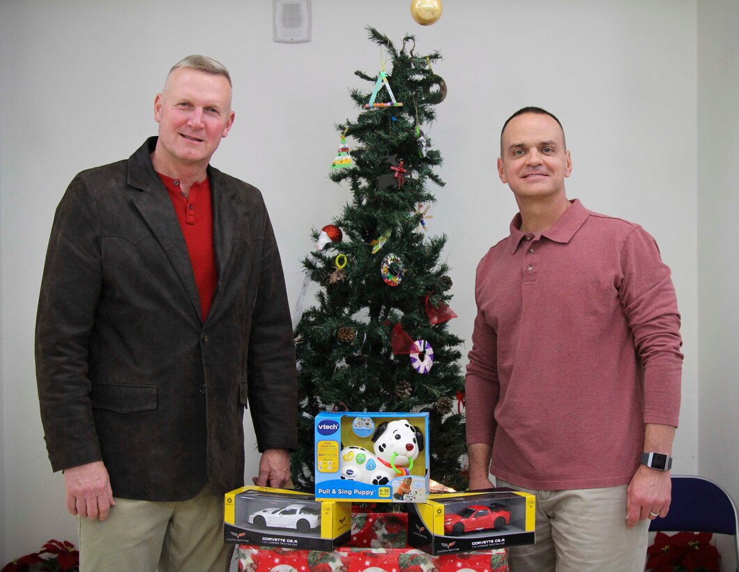 MARFORK Commanding General, Maj. Gen. James and Sgt. Maj. Saucedo thank the community for their generosity while participating in "Toys for Tots" 13, December. "Toys for Tots" is a non-profit program run by the U.S. Marine Corps that helps children who are less fortunate. (U.S. Marine Corps photo by Sgt. Parker R. Golz)